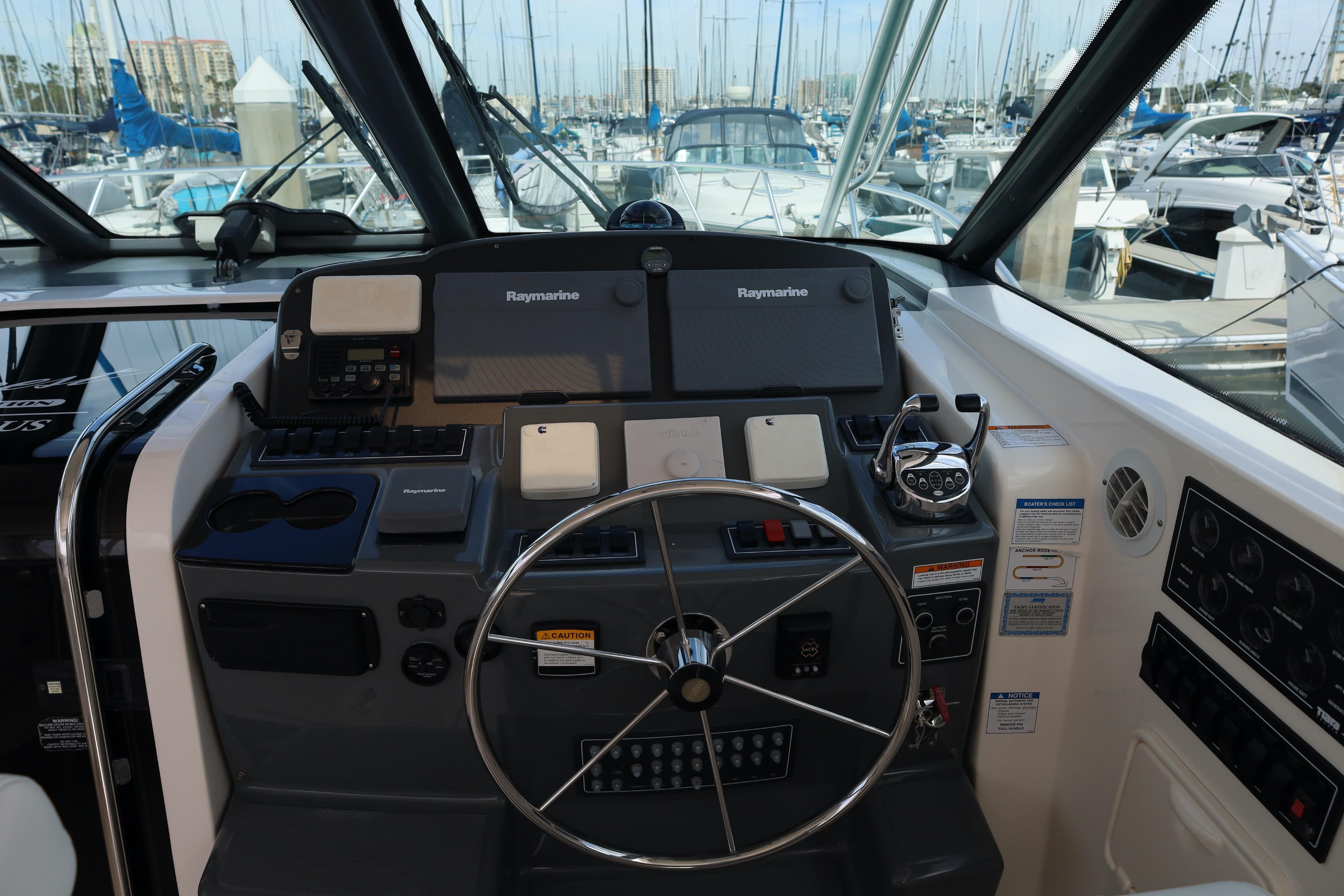 Helm of 2007 Tiara 4200 Open yacht with Raymarine navigation system, docked at marina.