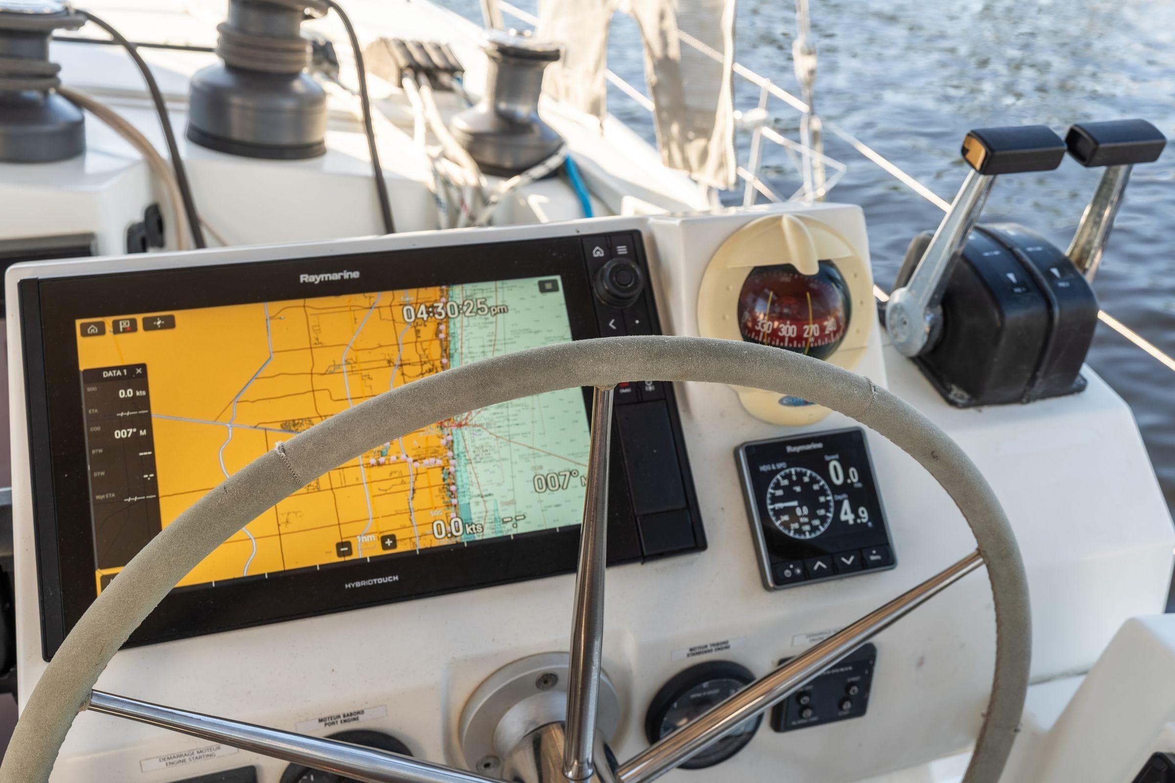 Cockpit of 2019 Fountaine Pajot 47 catamaran with navigation equipment and steering wheel.