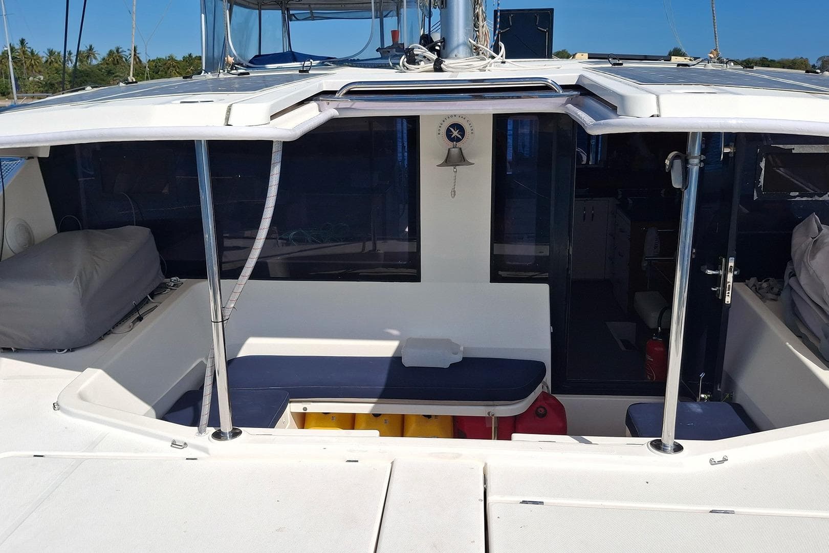 2013 Leopard 48 catamaran cockpit with seating, bell, and covered cushions.