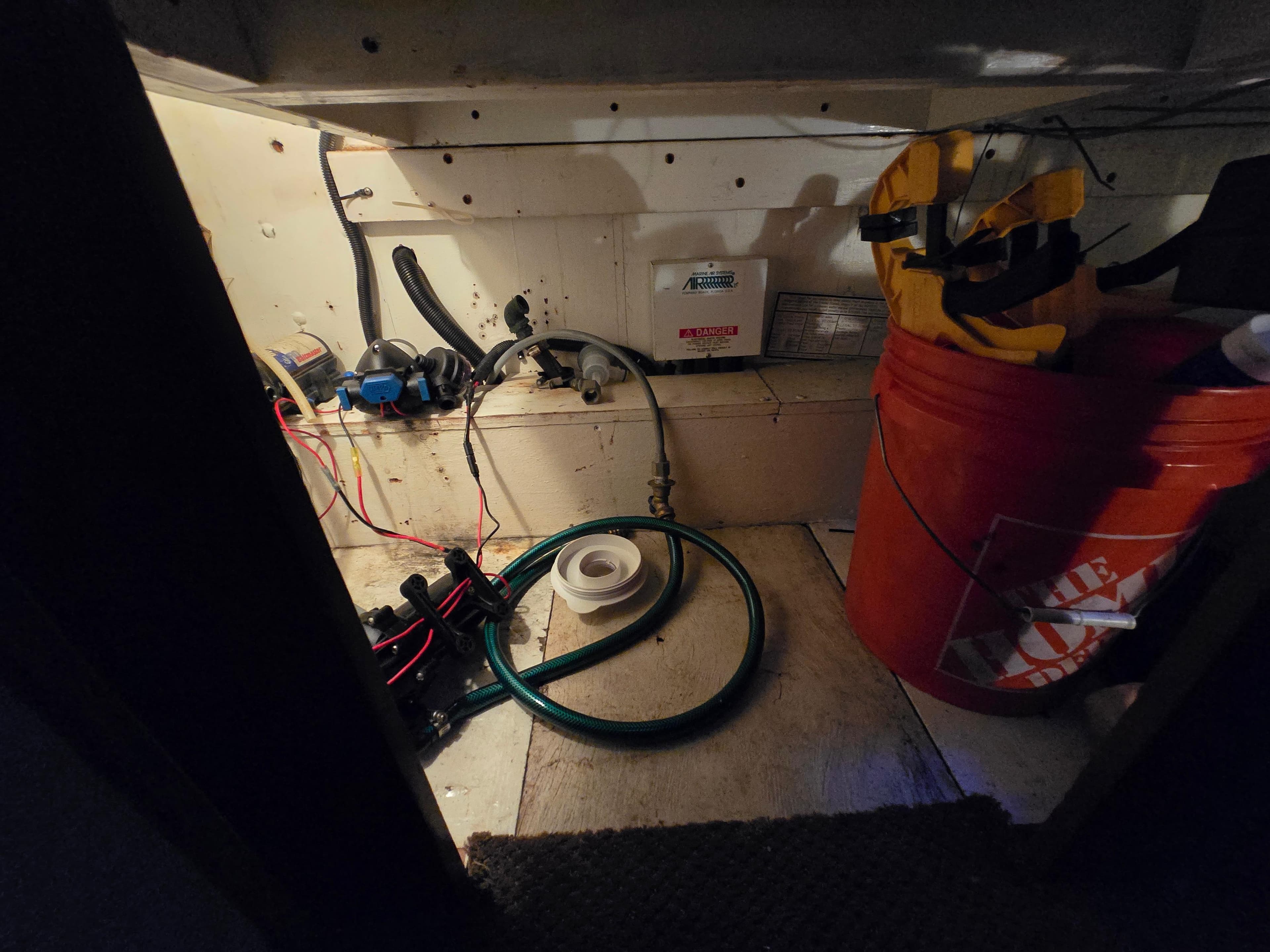 Storage area on a 1995 Egg Harbor 42 Convertible boat with tools and equipment.