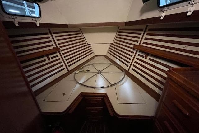 1983 Endeavour 35 sailboat interior with wooden paneling and storage compartments.