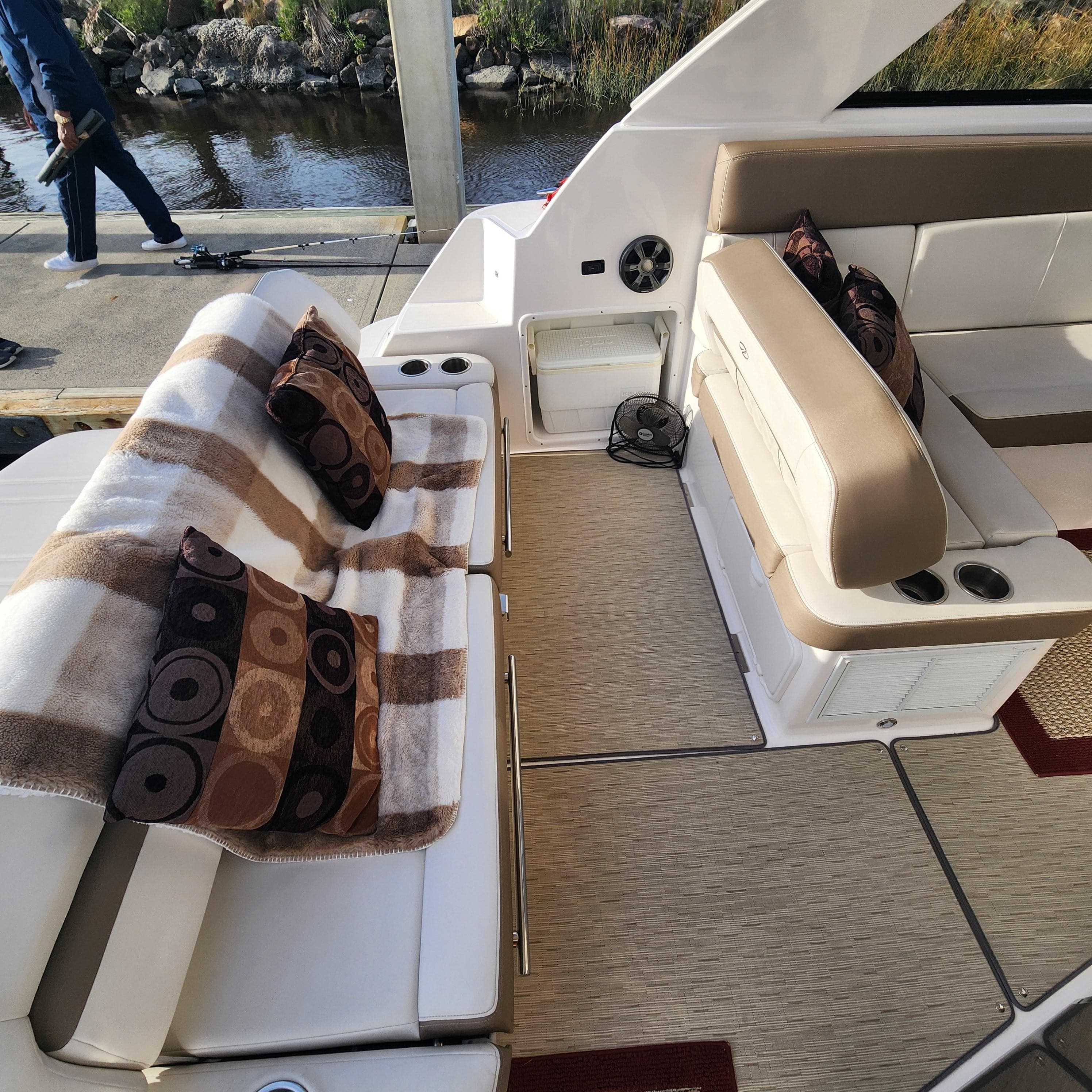 Interior of 2018 Regal 35 Sport Coupe with seating, pillows, and blanket.