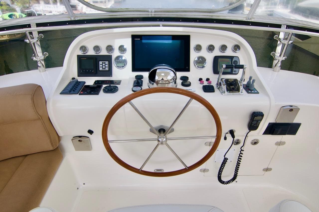 Helm of 2007 Norseman 560 Sedan with modern navigation controls and wooden steering wheel.