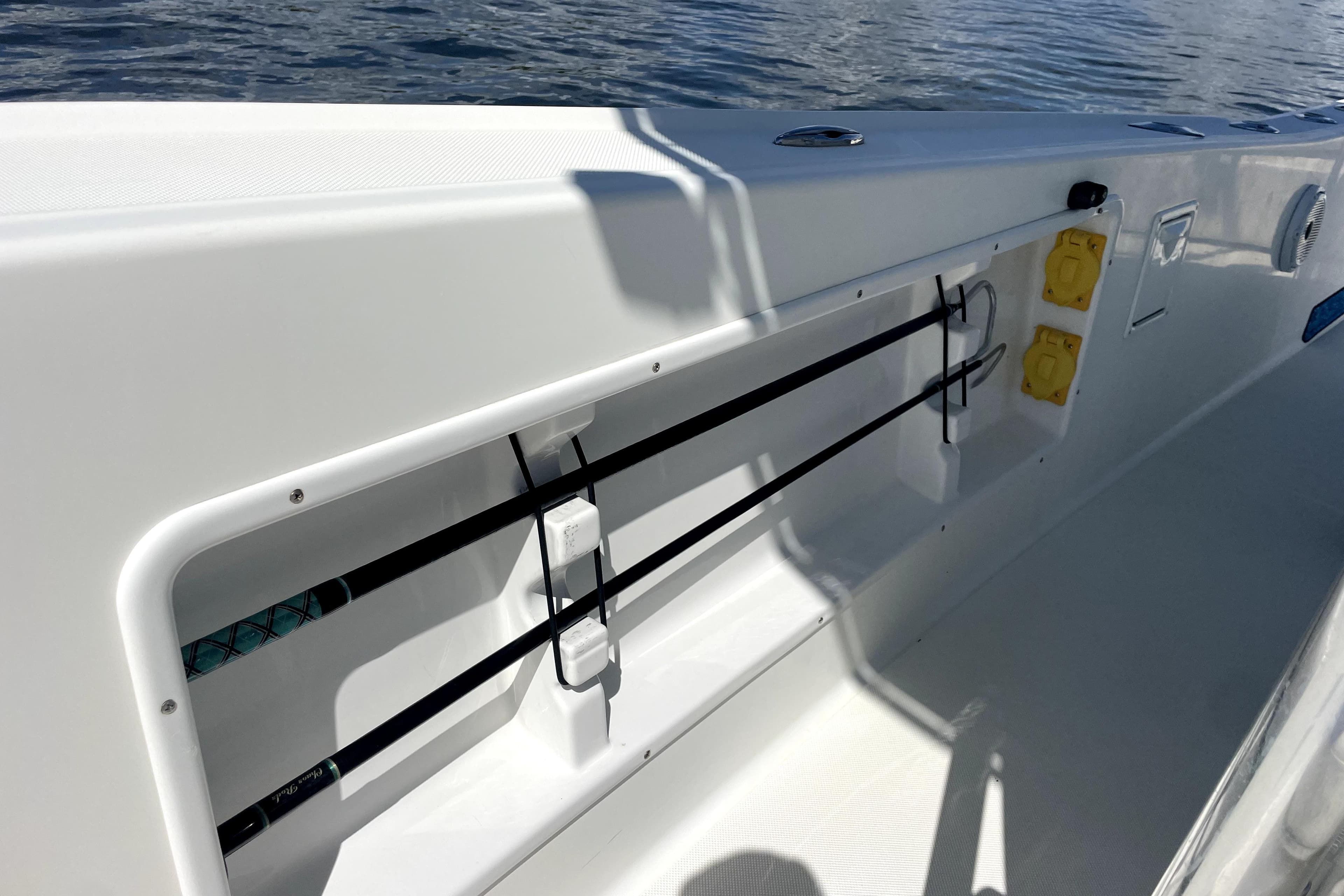 2013 Ocean Master 27 Center Console boat with rod holders and electrical outlets.