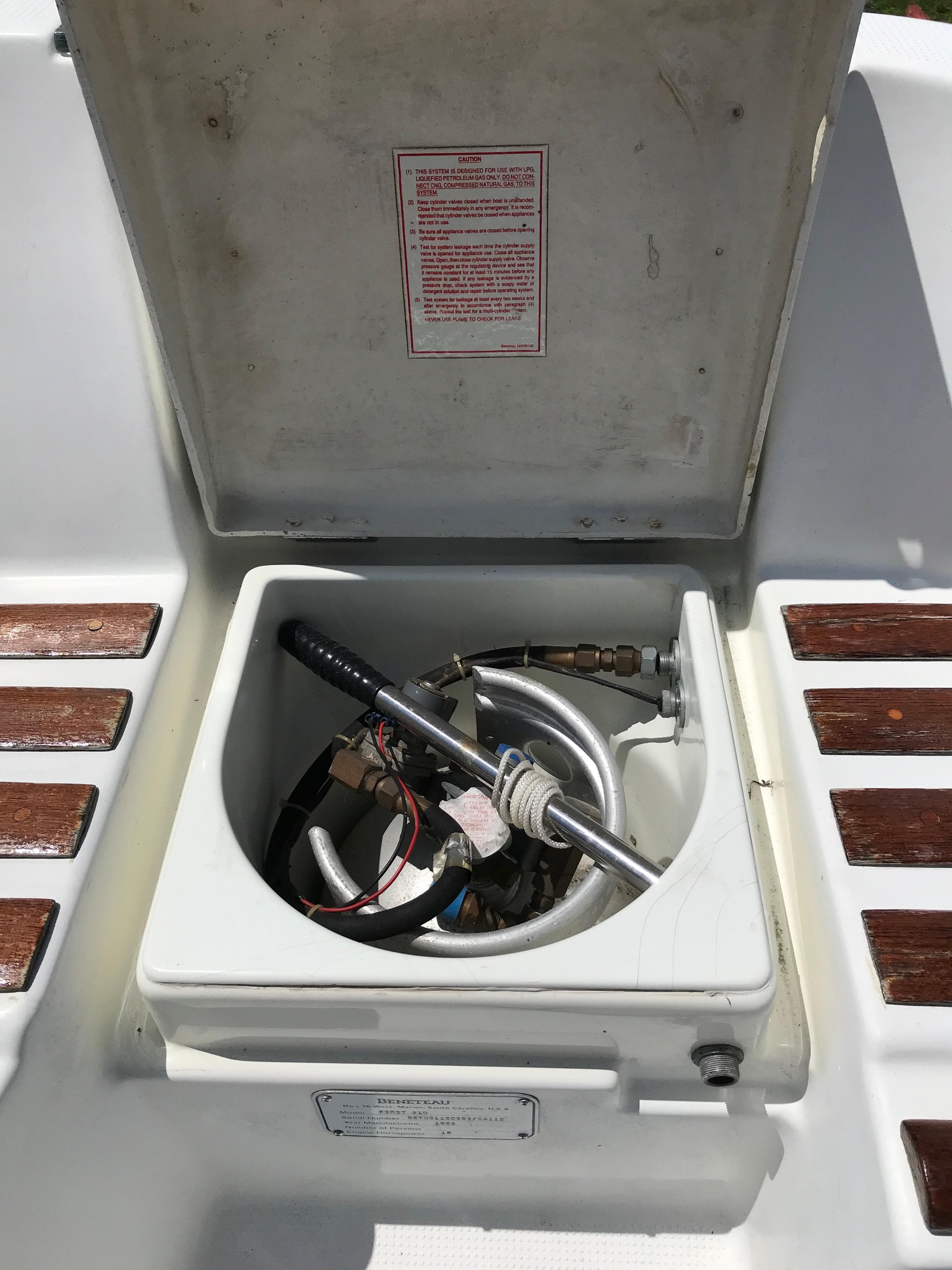 Open storage compartment on 1993 Beneteau First 310 sailboat deck.