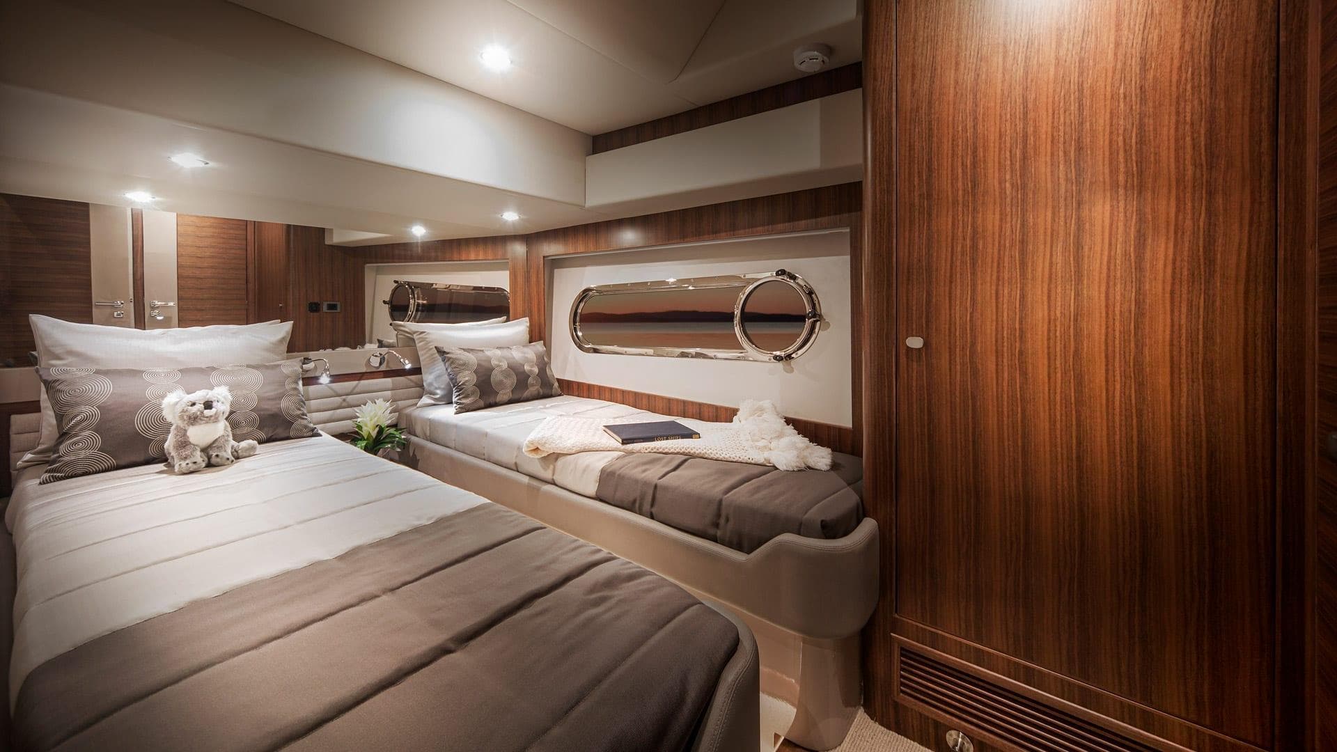 Luxurious cabin interior of the 2024 Belize 66 Daybridge yacht with twin beds.