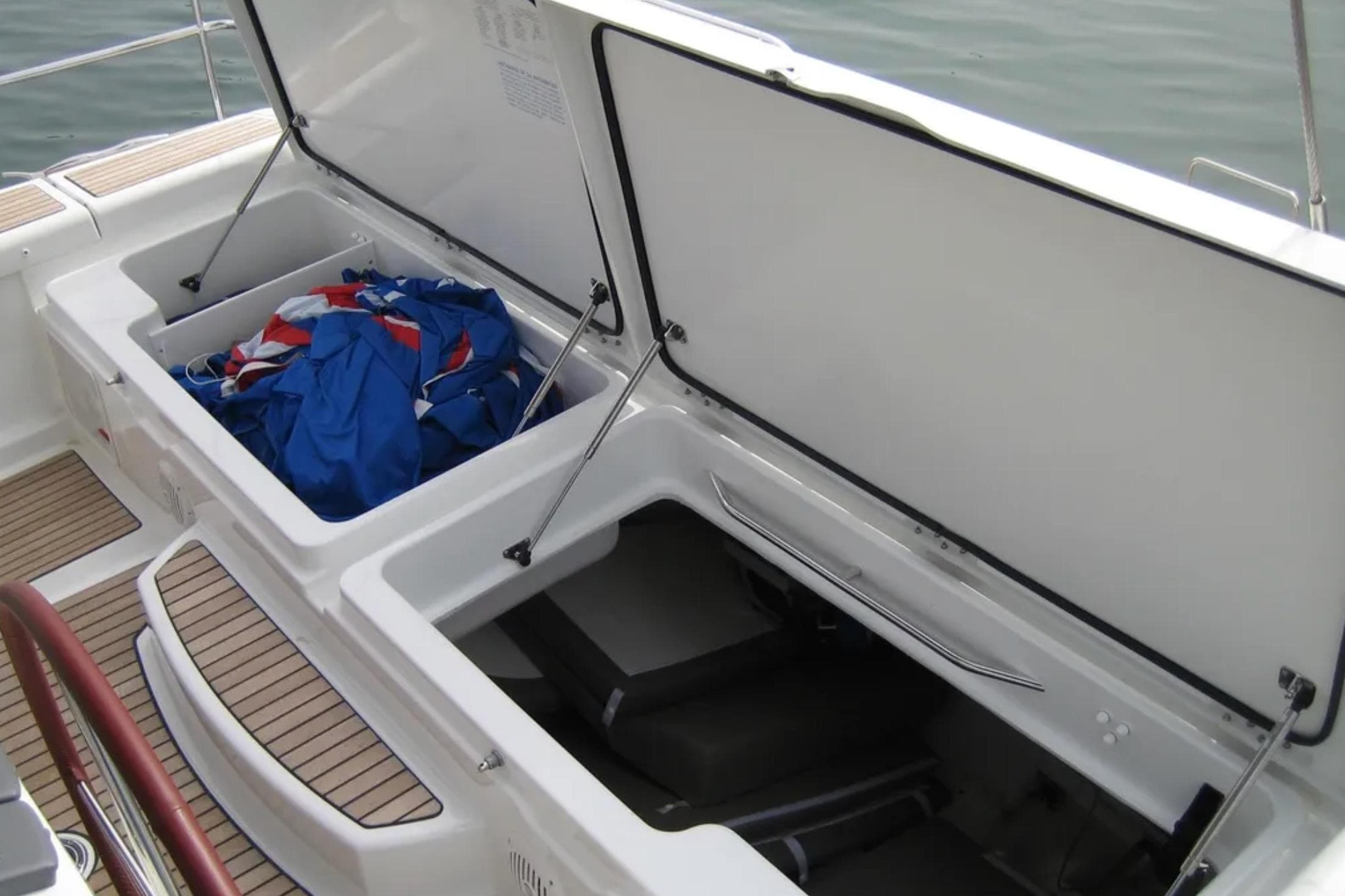 Open storage compartments on a 2013 Jeanneau 57 yacht, featuring deck and equipment.