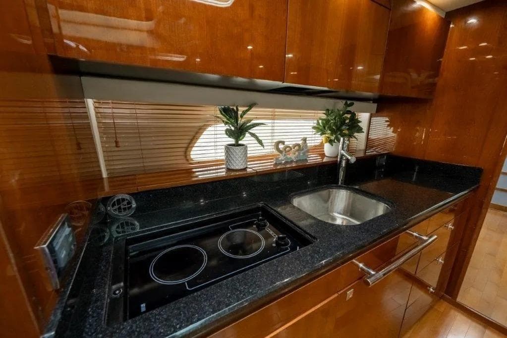 Luxurious kitchen interior of 2009 Sea Ray 43 Sundancer yacht with sleek countertops.