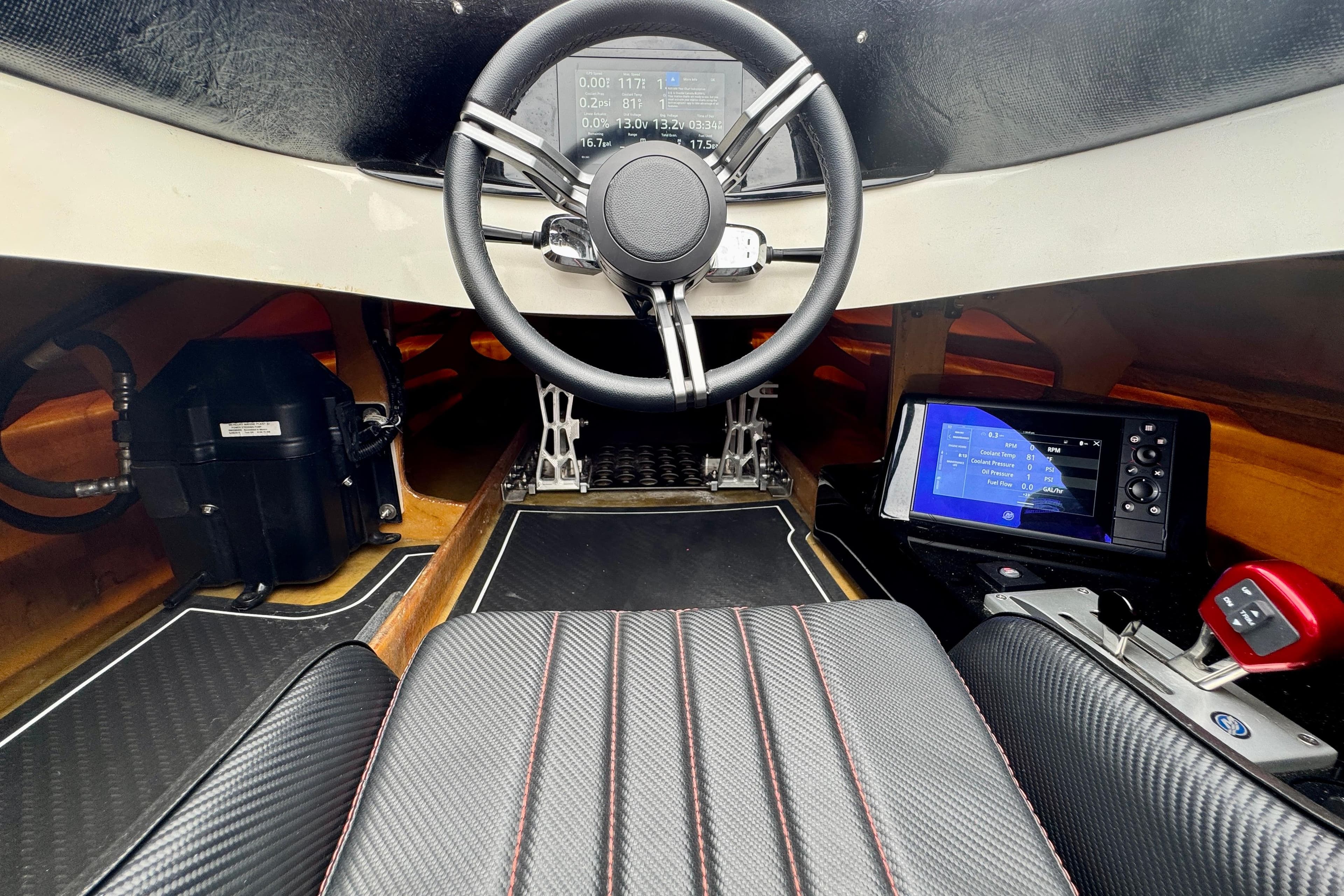 Interior of a 2016 Argo 23 boat with steering wheel and digital displays.