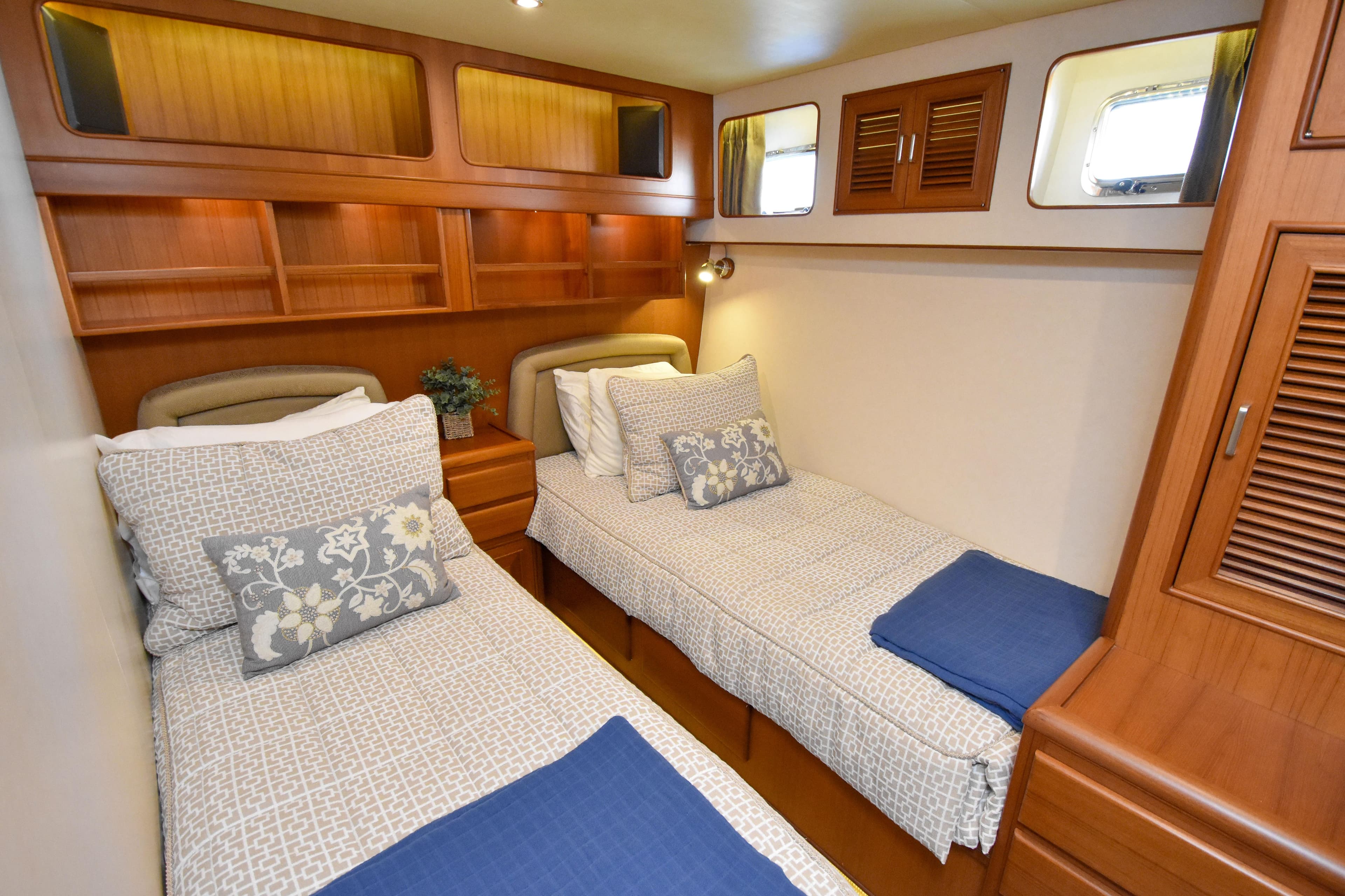 Luxurious twin cabin in 2013 Fleming 55 yacht with elegant wood finishes.