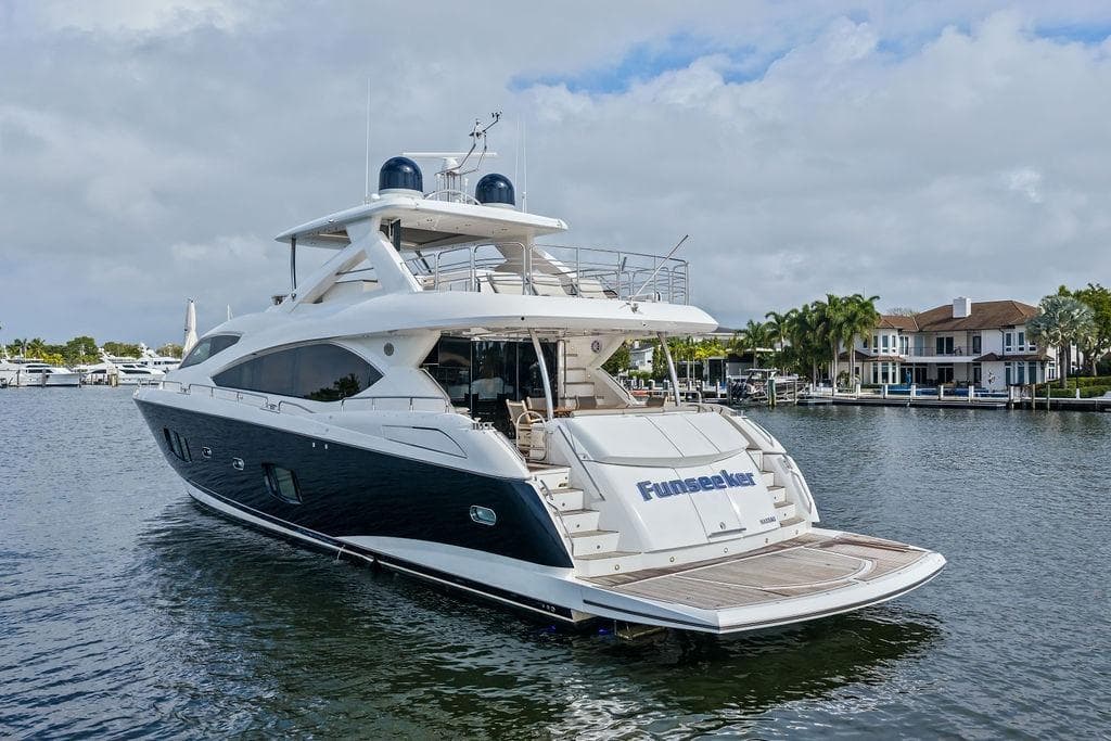 Luxurious 2012 Sunseeker 88 Yacht docked in a serene marina setting.