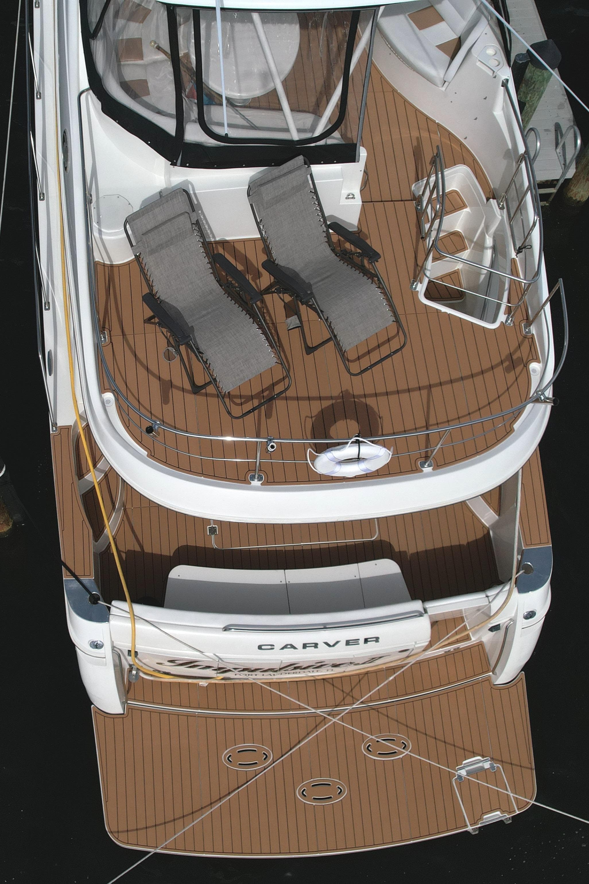 2006 Carver 56 Voyager yacht with spacious deck and lounge chairs.