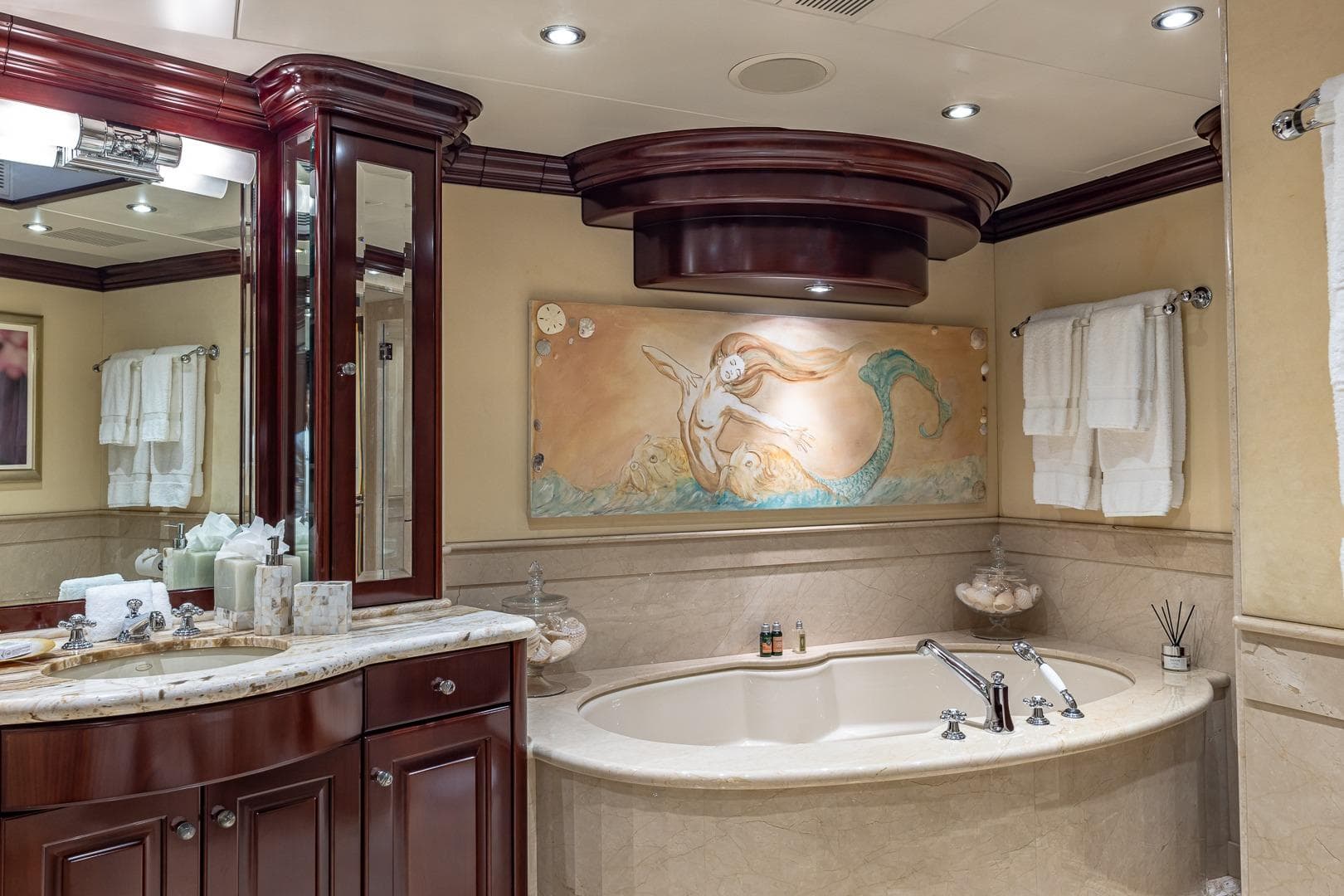 Luxurious yacht bathroom with mermaid artwork, marble fixtures, and elegant wood cabinetry, Christensen Tri-Deck 2007.