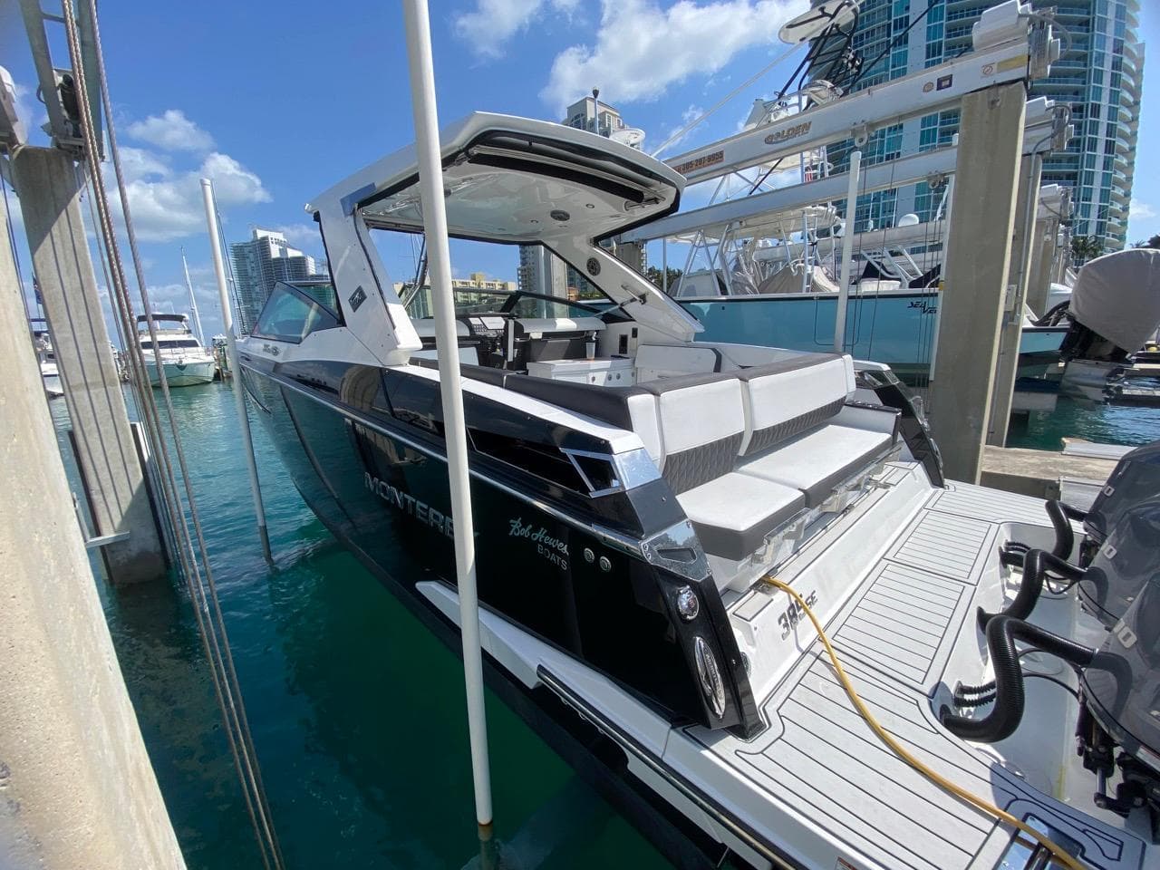 2018 Monterey 385 SE yacht docked at marina, featuring sleek design and spacious seating.