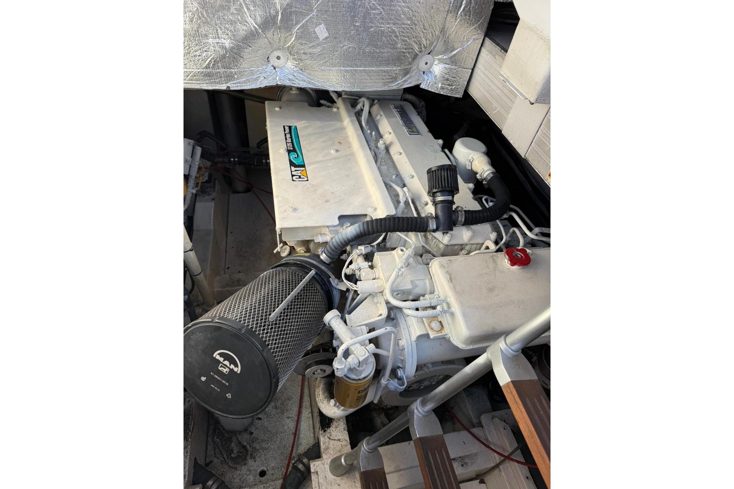 Engine compartment of a 2002 Pershing 37 yacht, featuring a CAT marine engine.