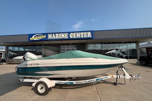 2000 Glastron GX 180 boat on trailer outside Marine Center dealership.