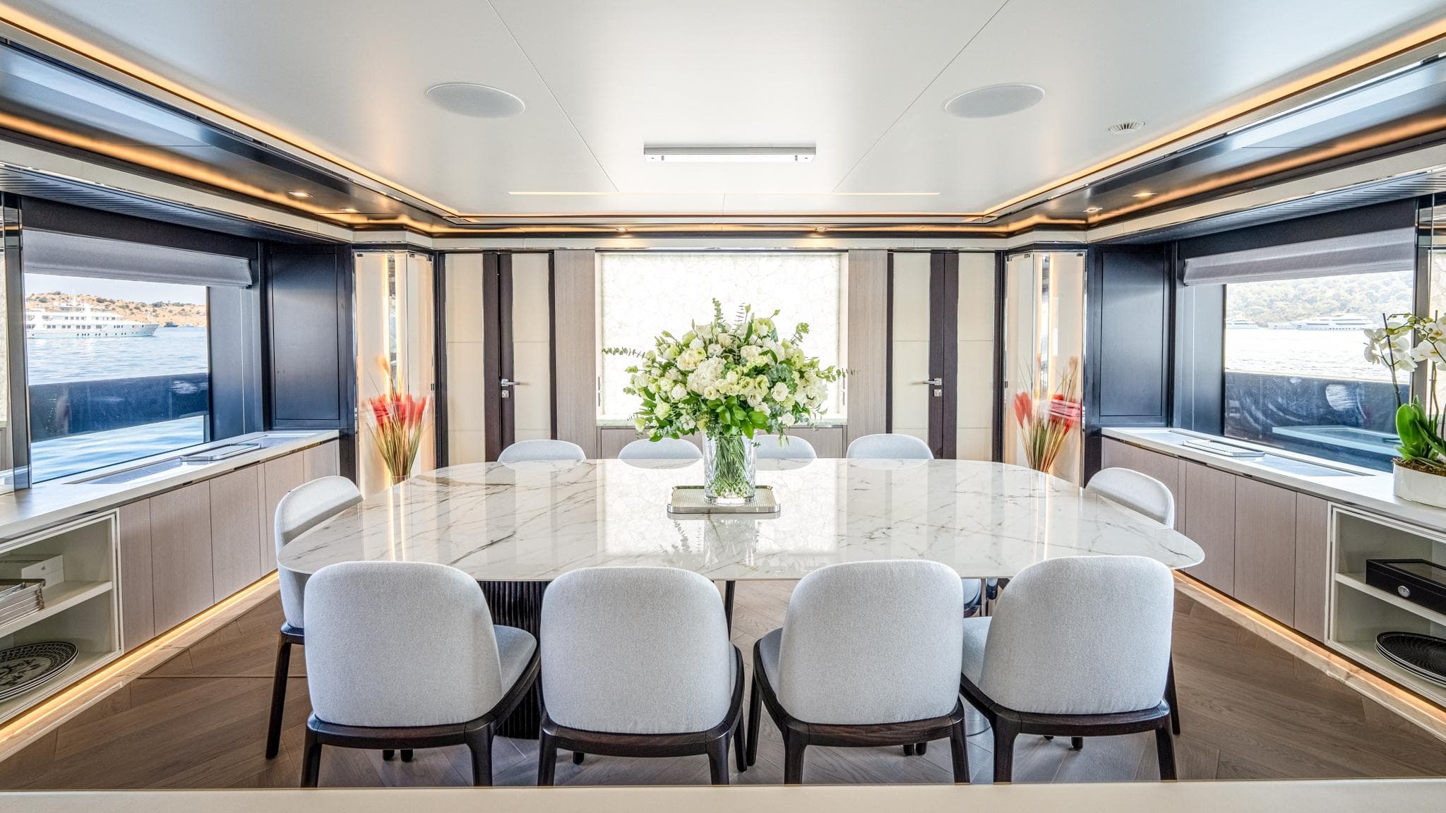 Luxurious dining area on a 2016 Mondomarine 50-metre yacht, featuring elegant decor and large windows.
