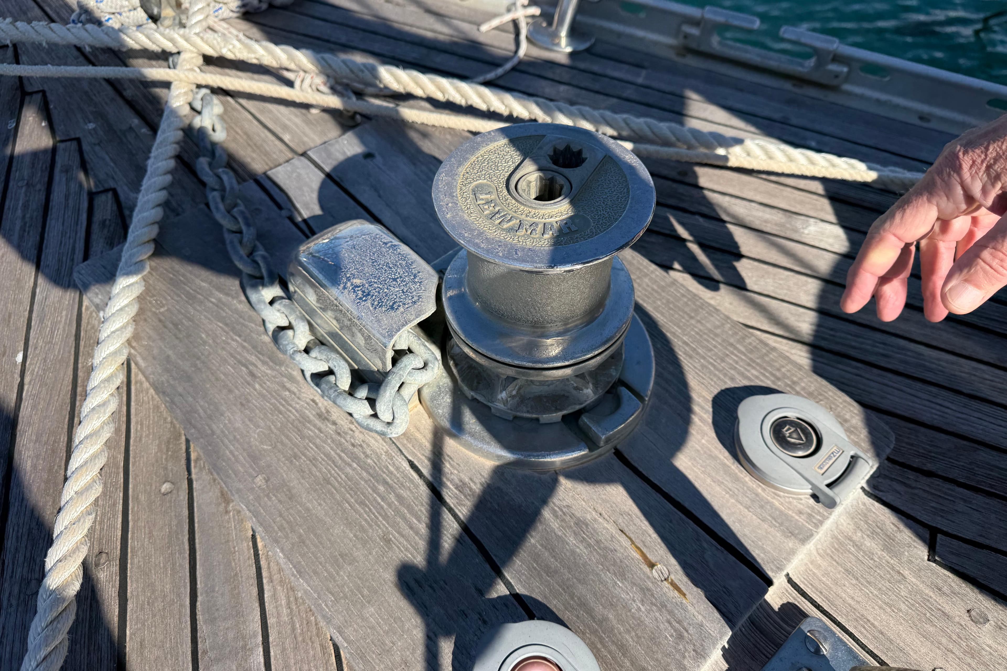 Deck of 1983 Moody 134 Grenadier yacht with winch and ropes.