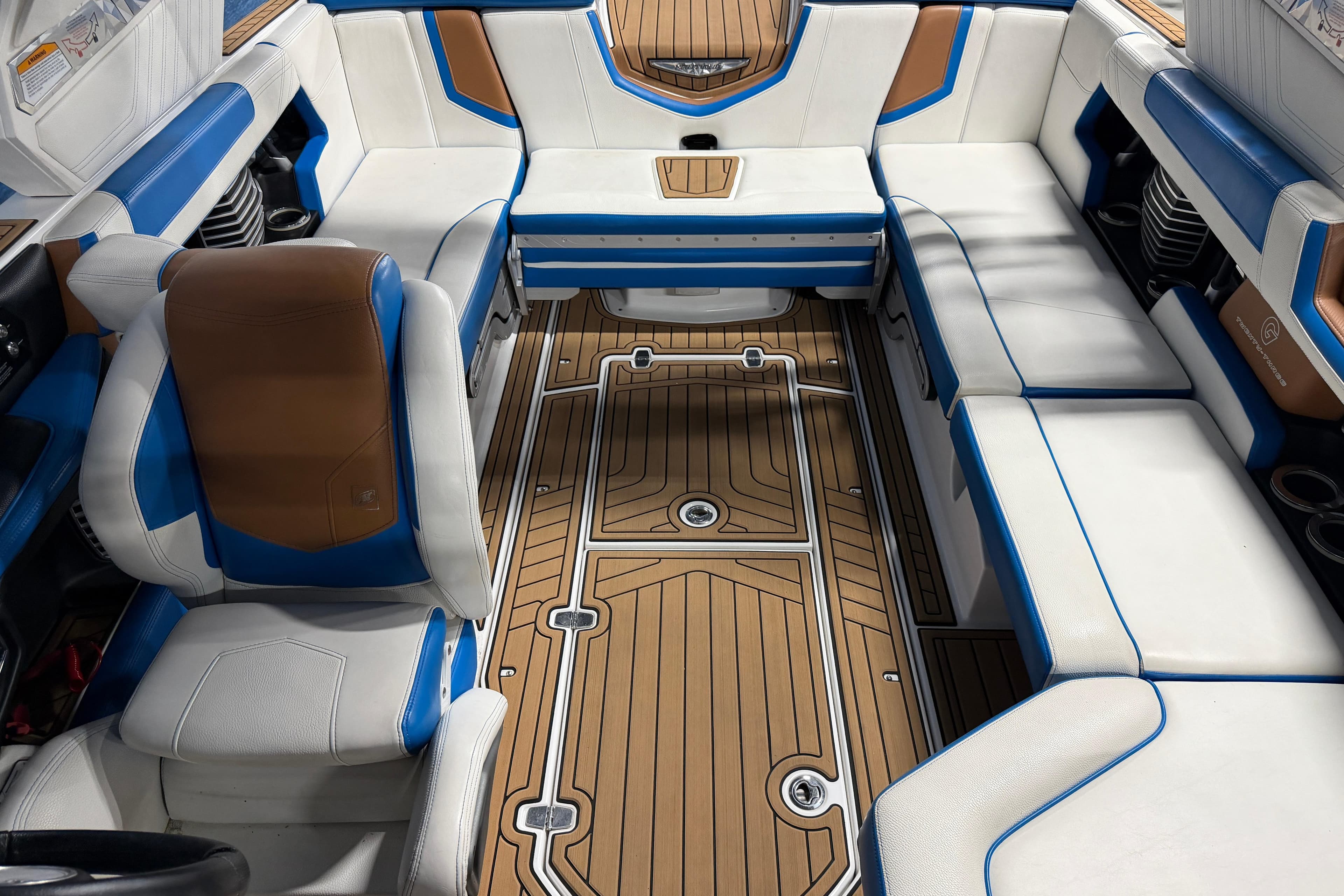 2019 Nautique Super Air Nautique G23 interior with white, blue, and brown seating.