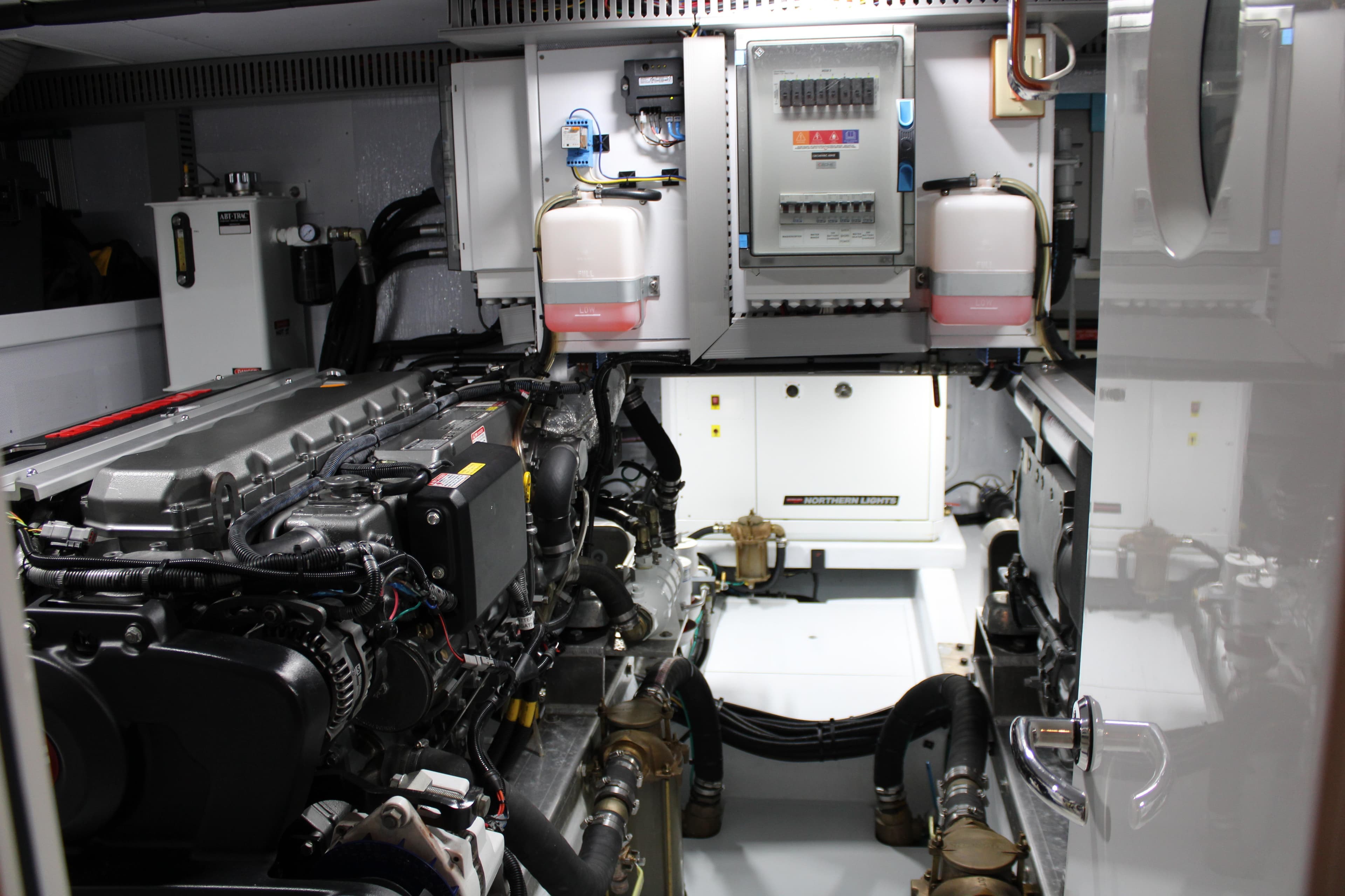 Engine room of 2023 Krogen Express 52' yacht, showcasing mechanical components and control panels.