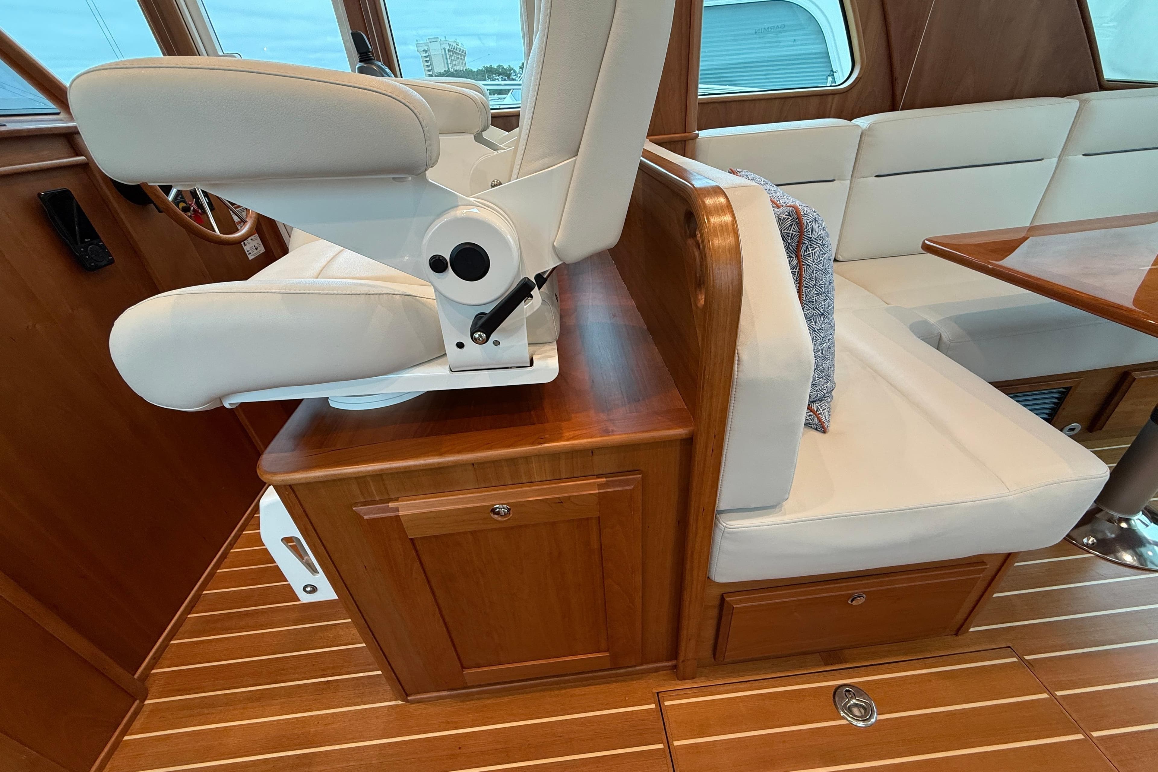 2023 Sabre 43 Salon Express interior with white seating and wooden finishes.