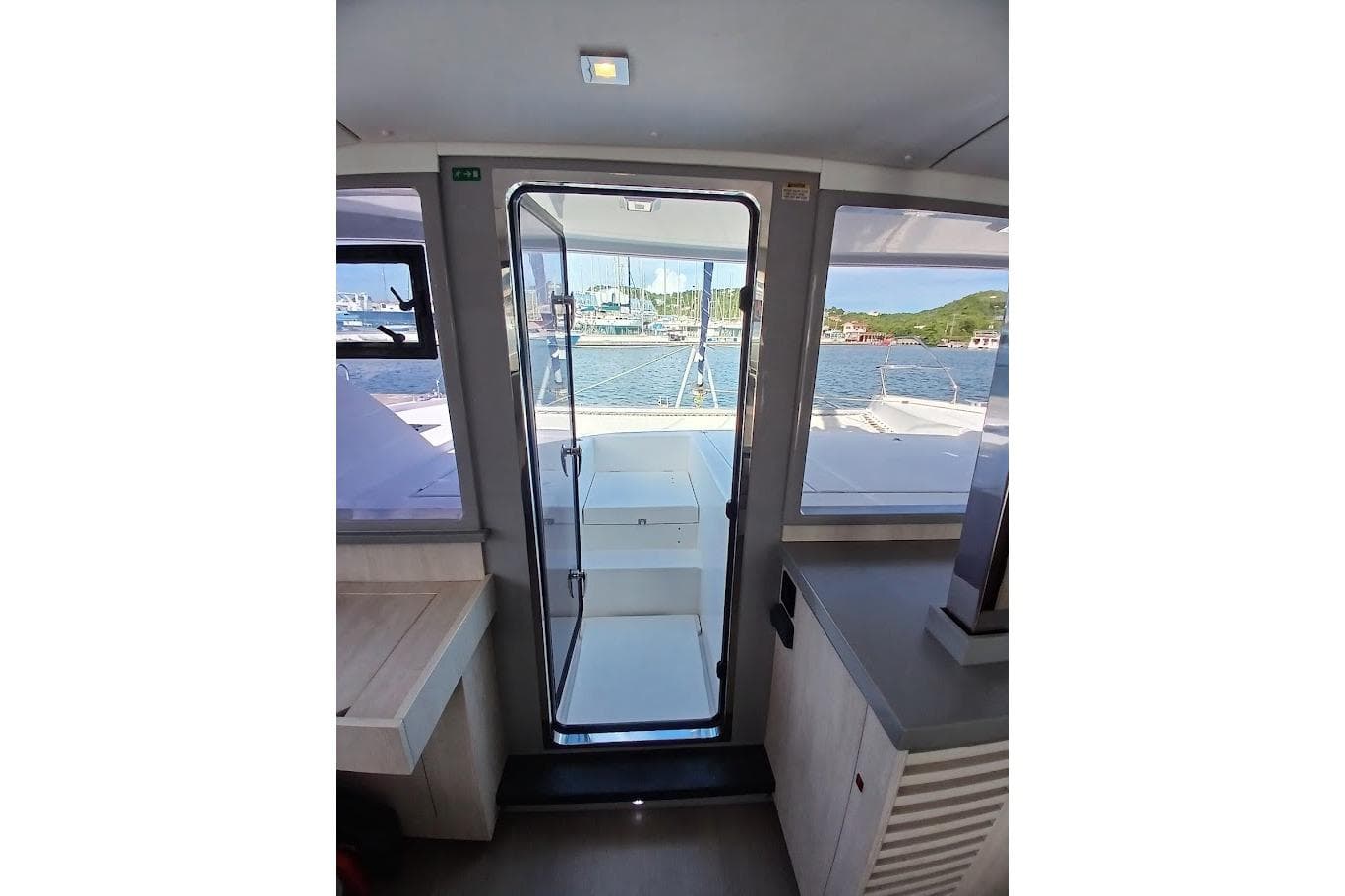 Interior view of 2020 Leopard 40 catamaran, showcasing modern design and ocean backdrop.