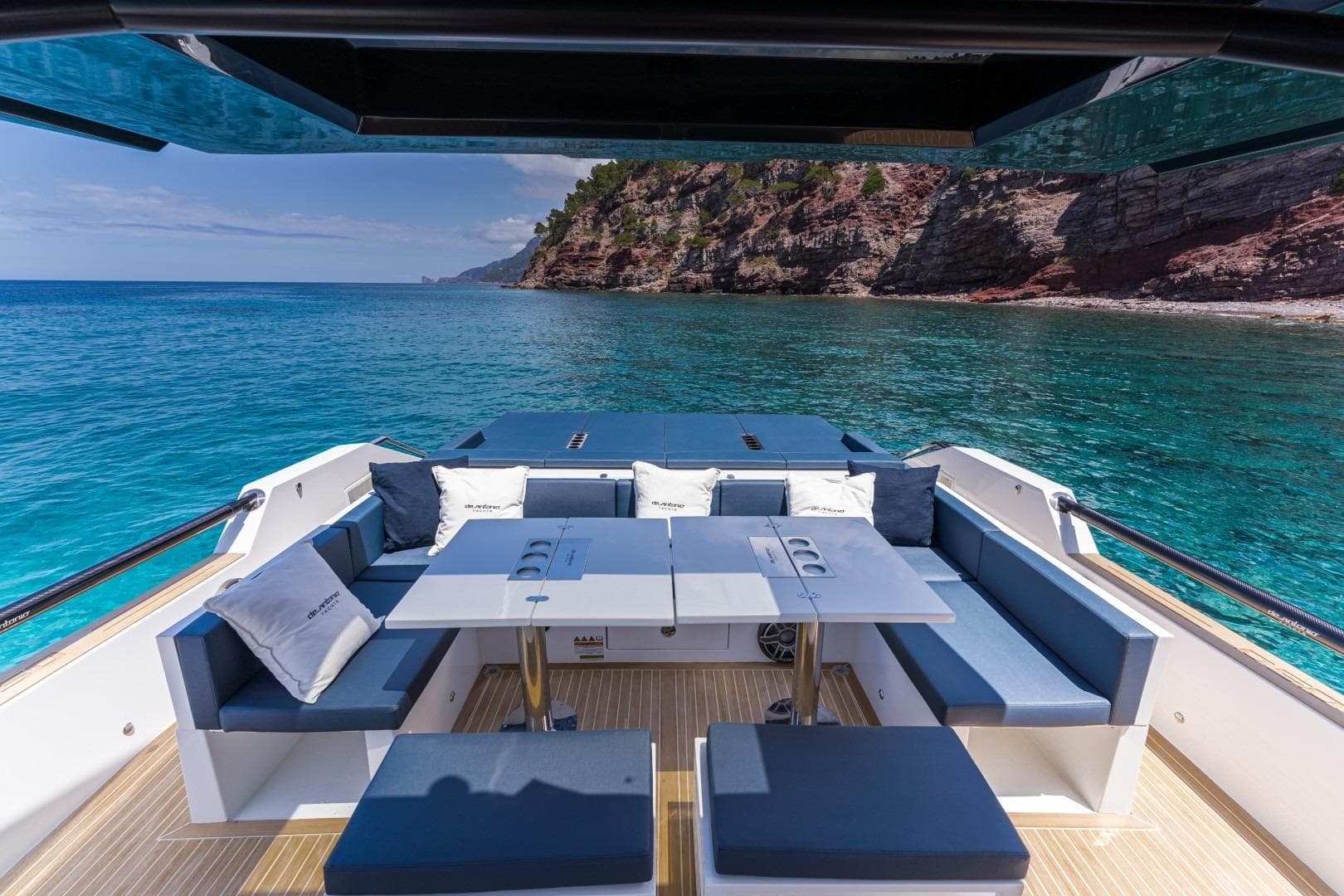 Luxurious 2026 De Antonio Yachts 50 Open with elegant seating, overlooking serene turquoise waters.