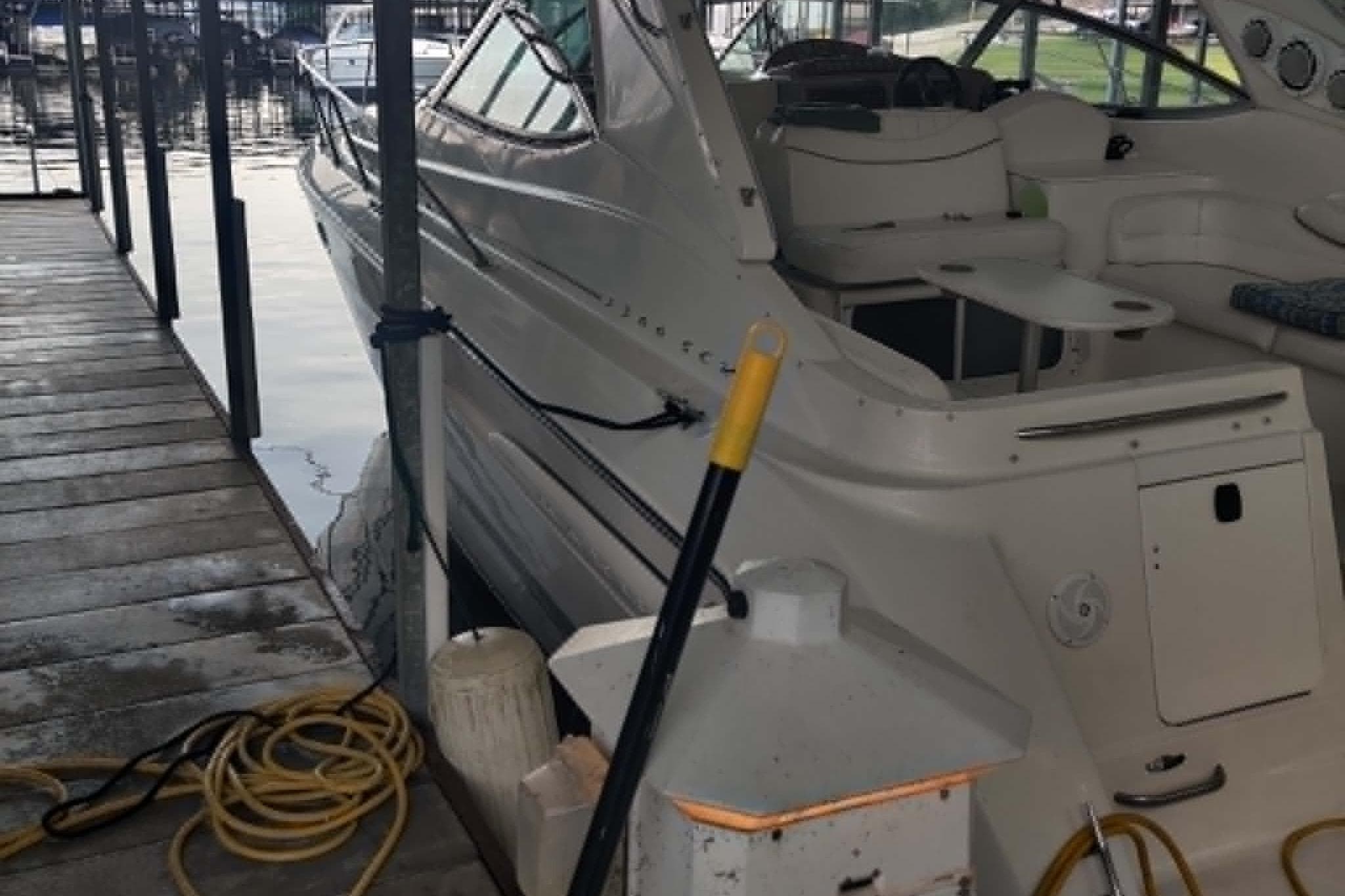 2001 Maxum 3300 SCR boat docked, showing interior seating and deck area.