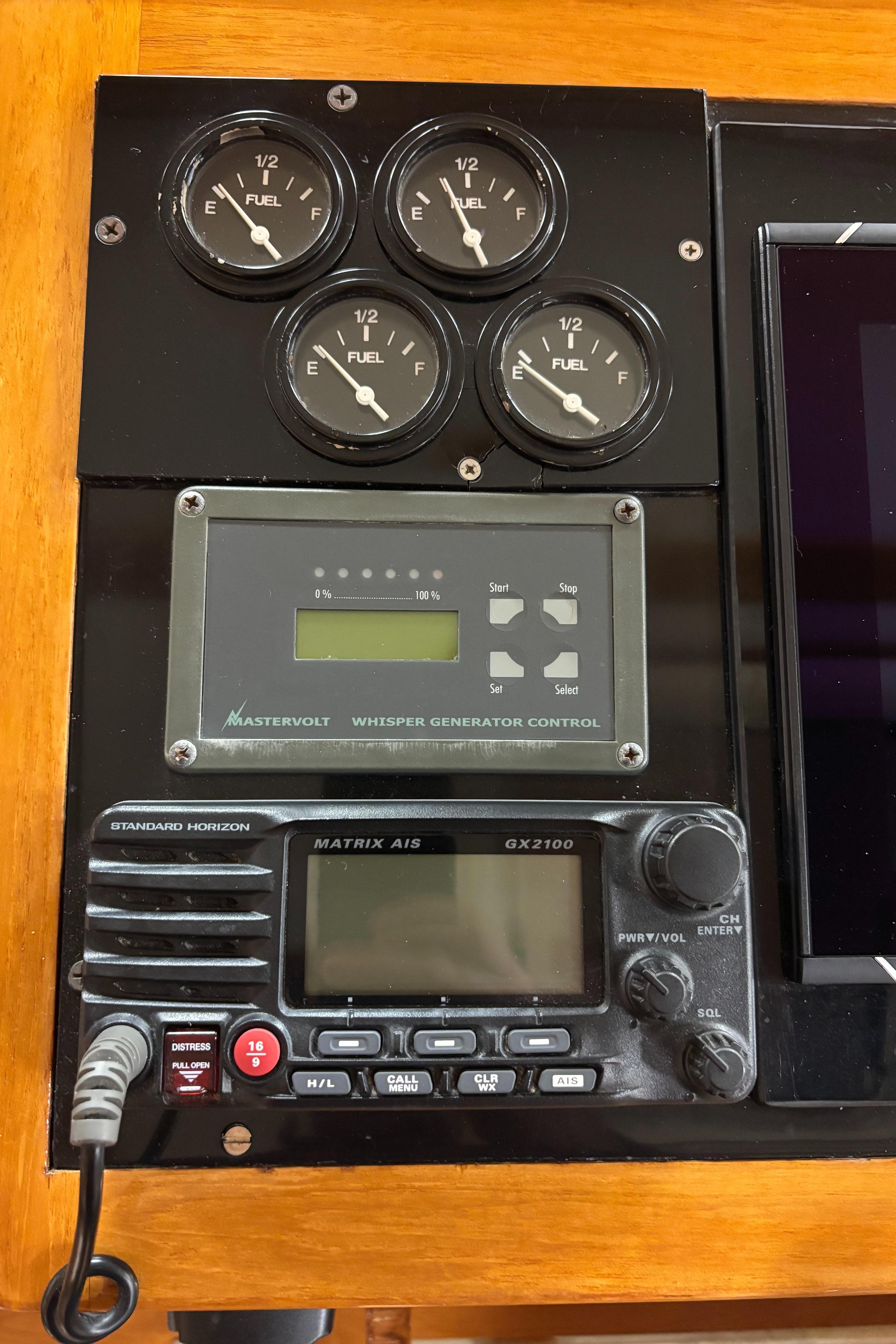 Control panel with fuel gauges, generator control, and radio on a 2006 Ellis Express.