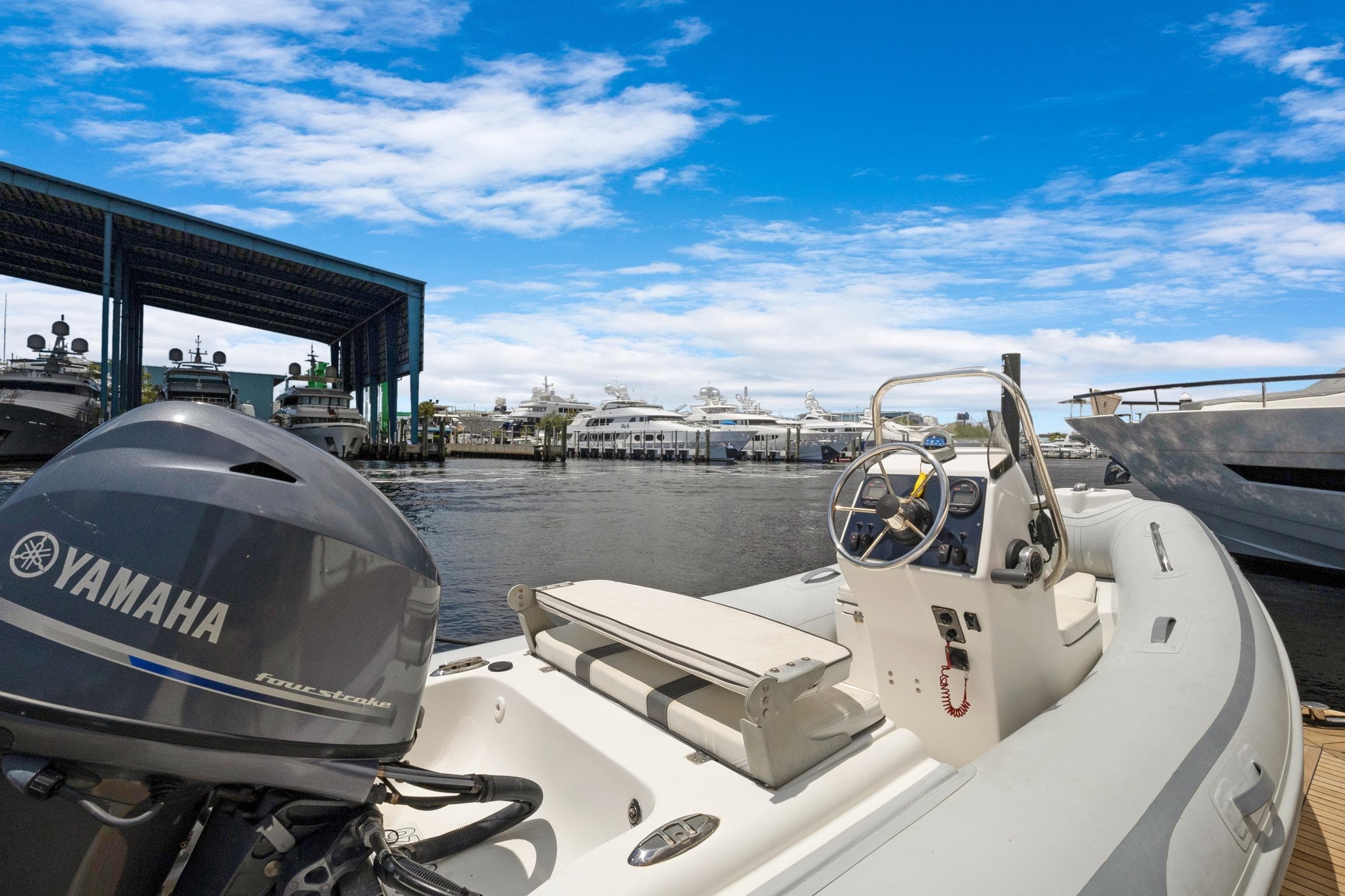 Boat docked at marina with Yamaha engine, clear blue sky, Marquis 690, 2008 model.