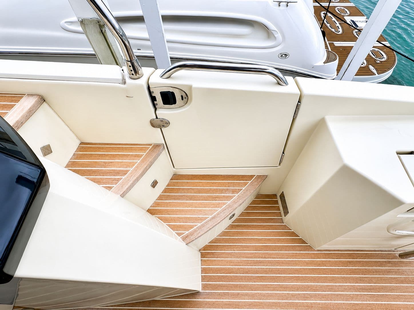 Monte Carlo MC6 2019 yacht deck with wood finish and stainless steel railing.