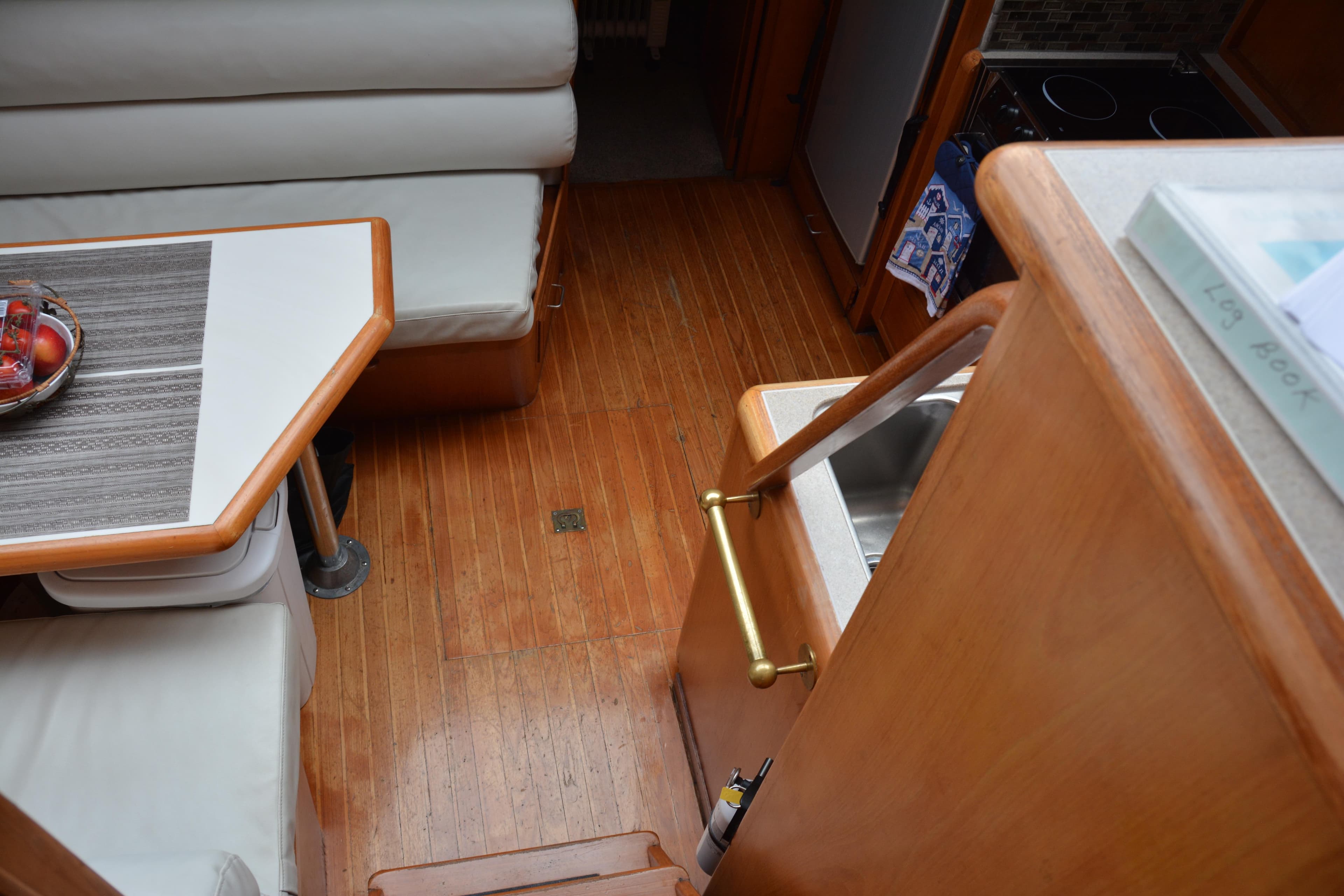 Interior of 1988 Camargue 48 Cockpit Motor Yacht with wooden flooring and dining area.