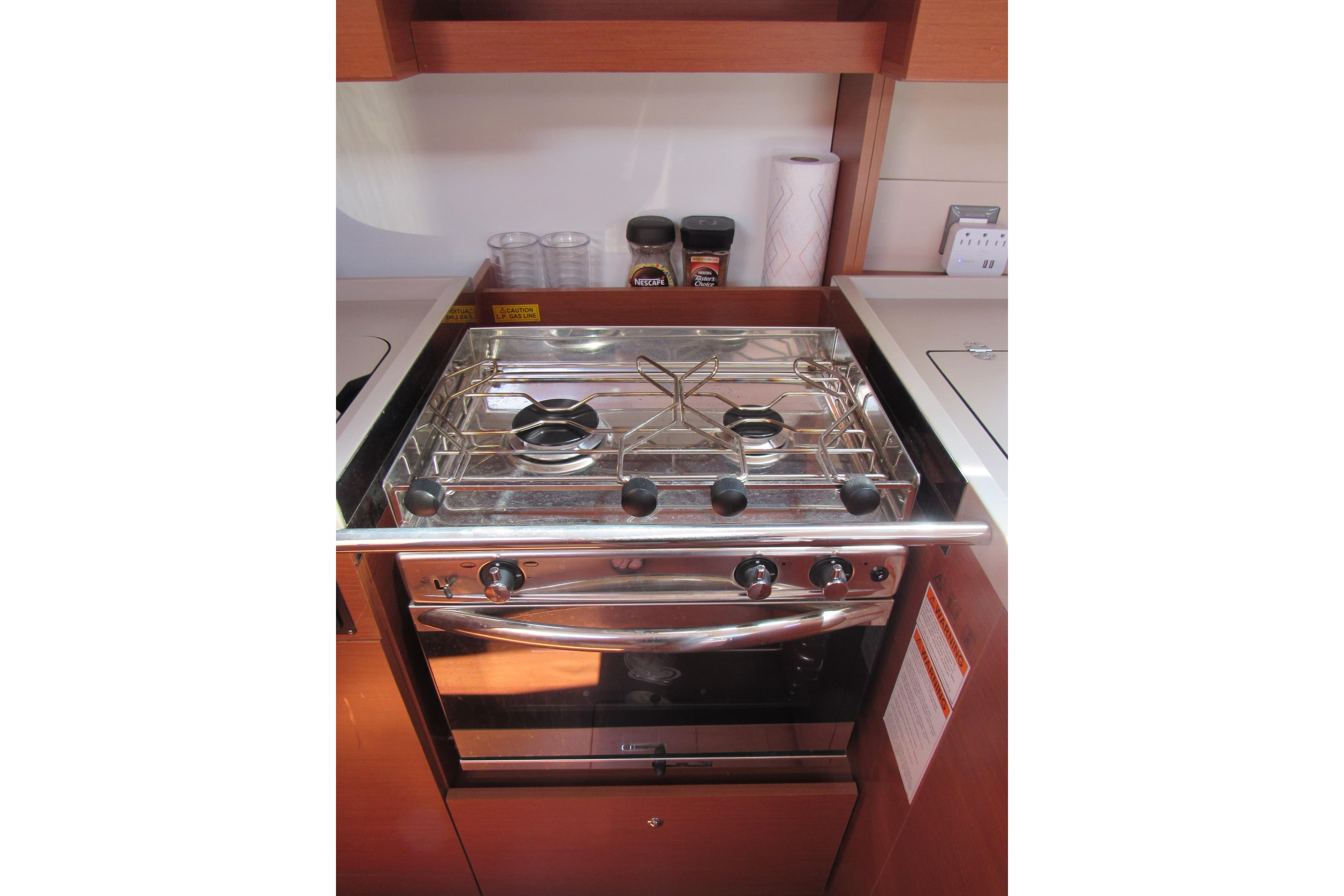 Modern kitchen stove in a 2020 Beneteau Oceanis 46.1 yacht galley.