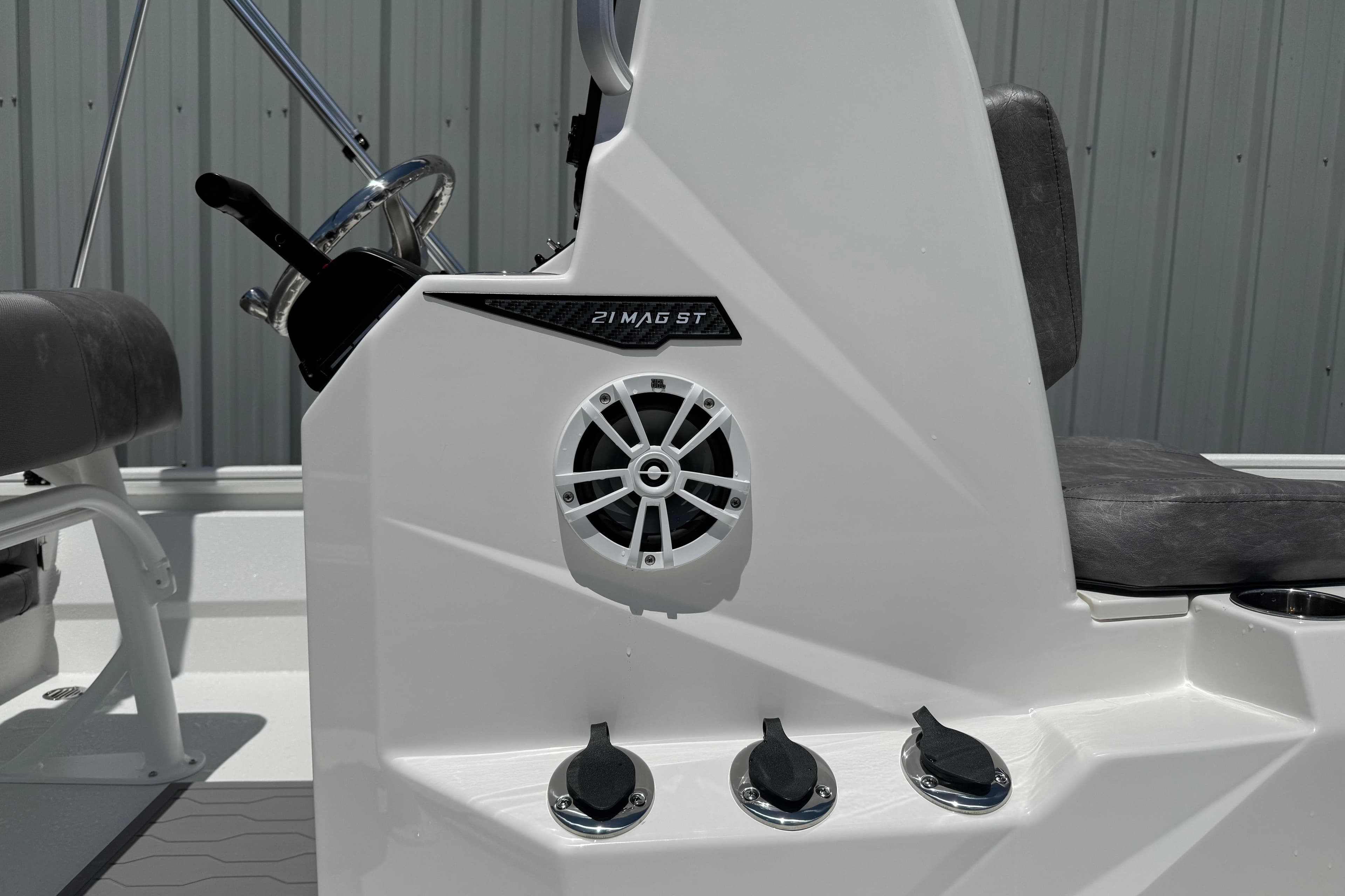 Avid 21 Mag 2026 boat console with speaker and controls, featuring sleek design.