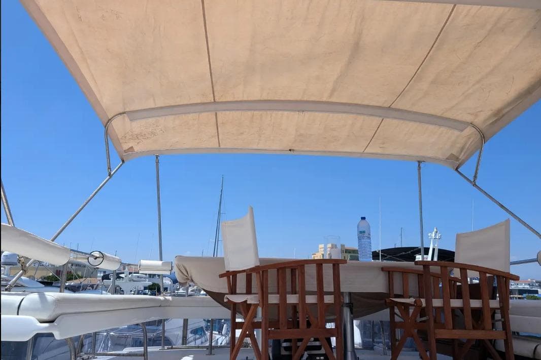 Deck view of 1989 Angel 56 Cruiser yacht with canopy and seating.