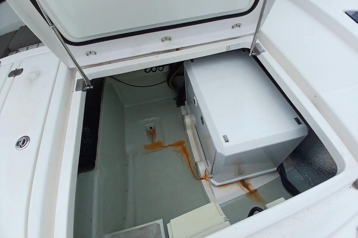 Open storage compartment on a 2019 Leopard 45 yacht, showing equipment and rust stains.