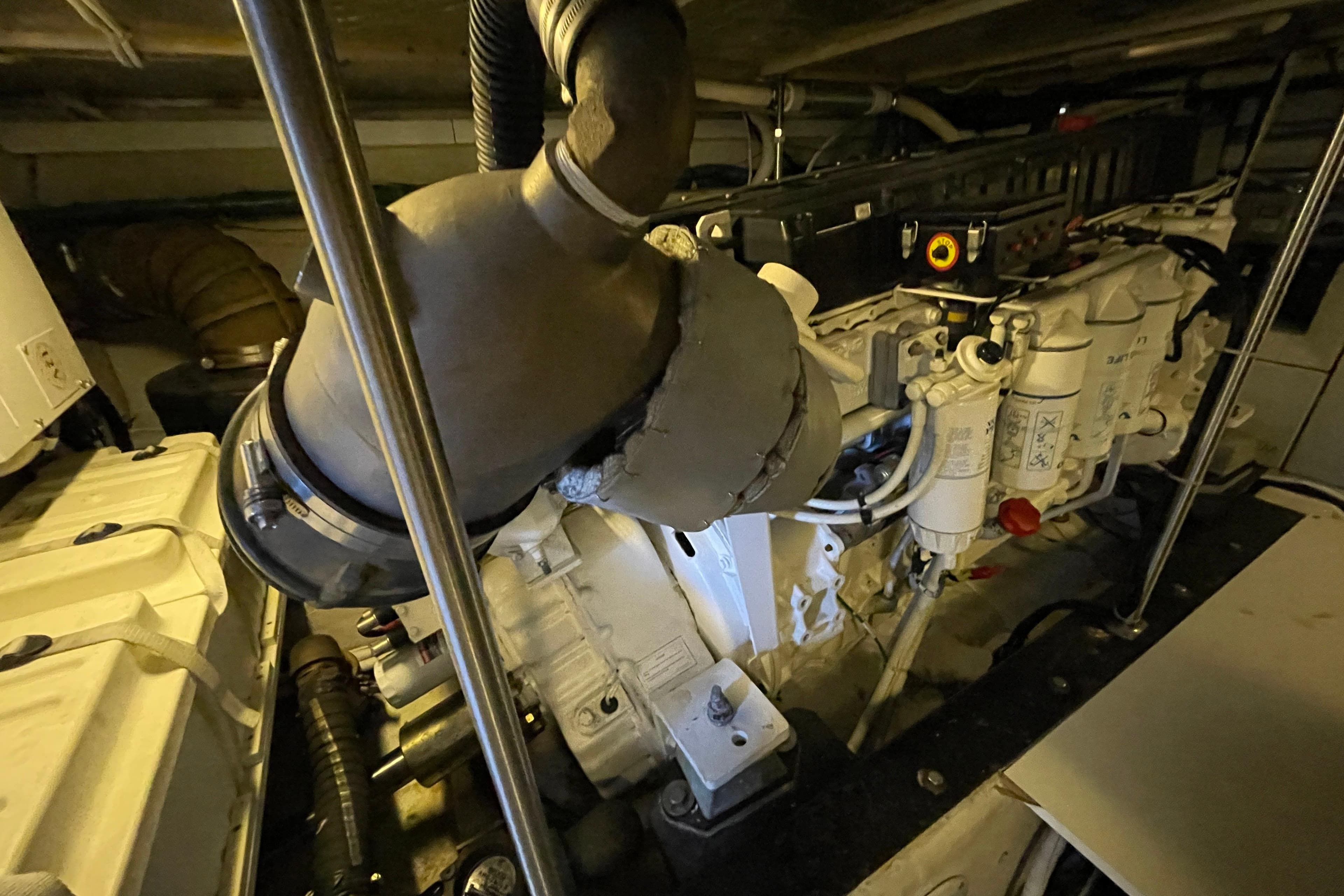 Engine room of 2002 Carver 570 Voyager Pilothouse, showcasing mechanical components and filters.