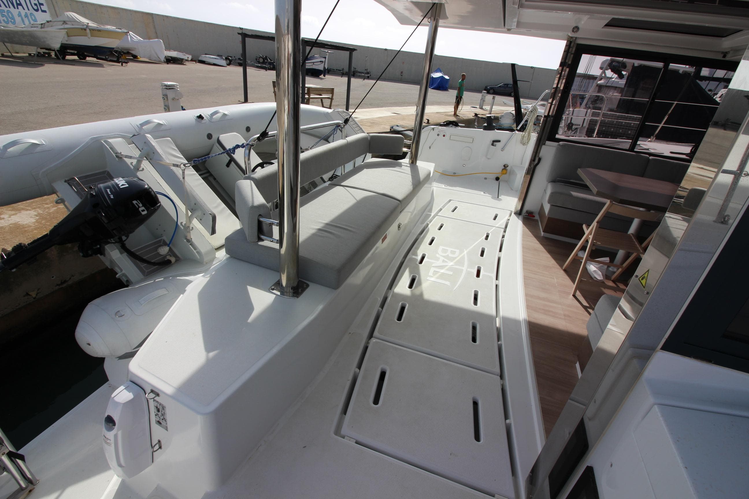 2022 Bali 4.6 yacht deck with seating and dining area, docked at marina.