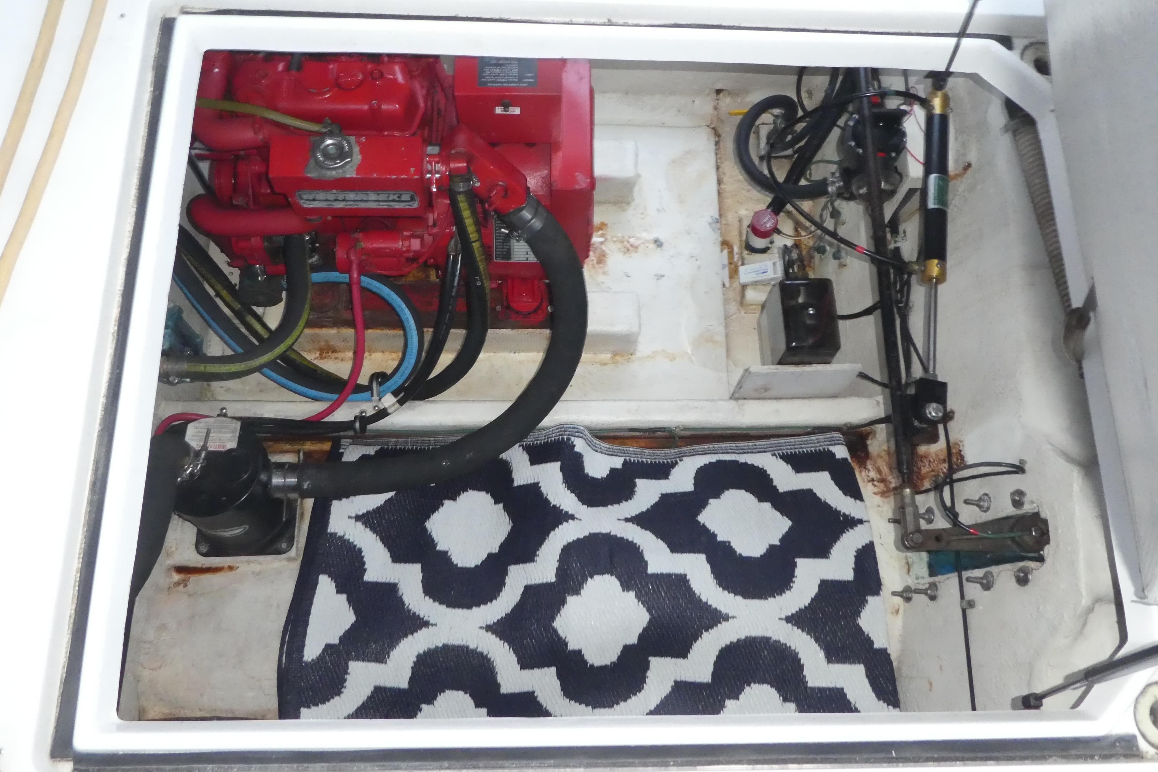 Engine compartment of 1994 Bayliner 4388 Motor Yacht with visible machinery and hoses.