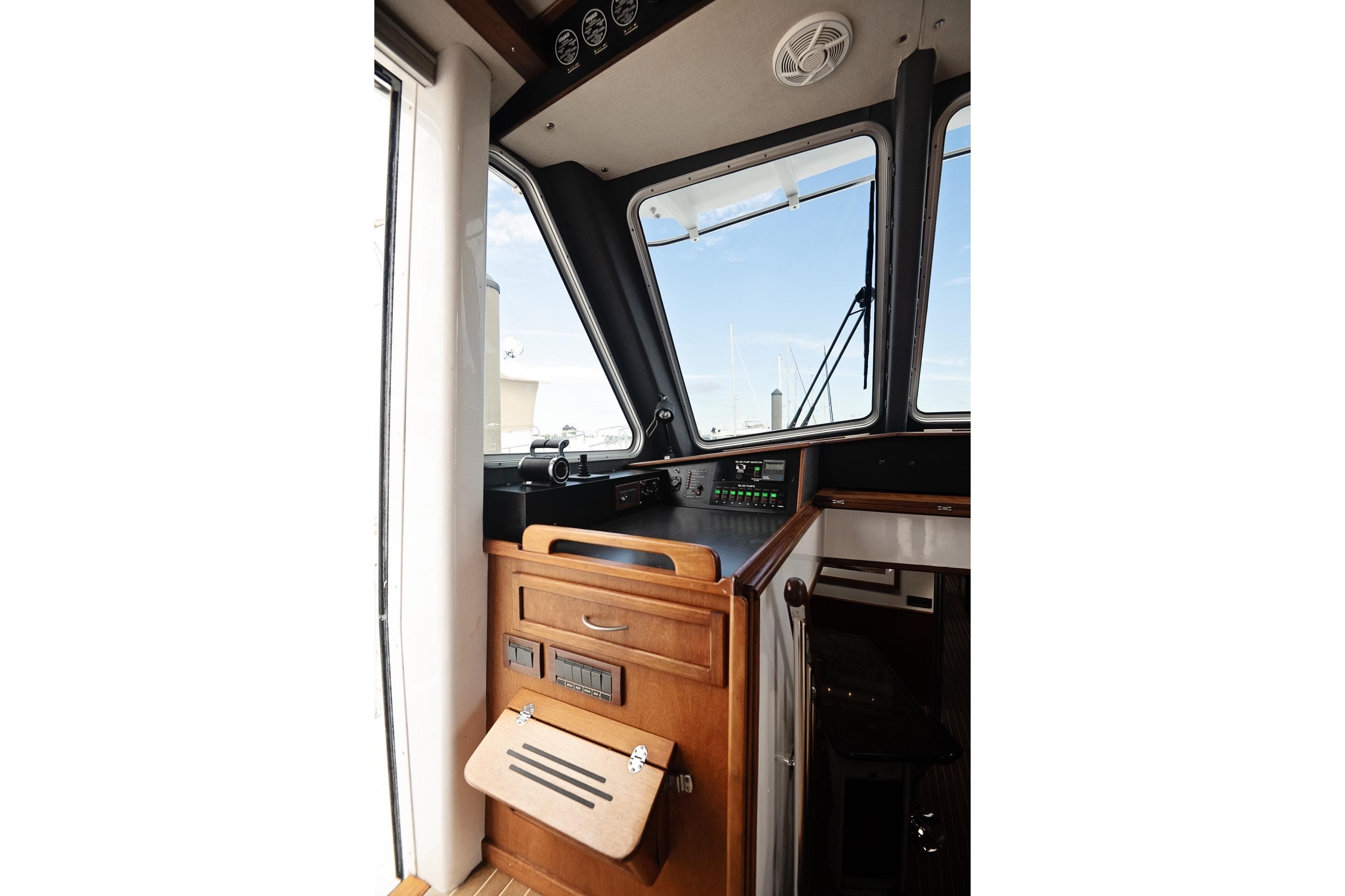 2007 Pilot Cruiser Expedition boat interior with control panel and wooden cabinetry.