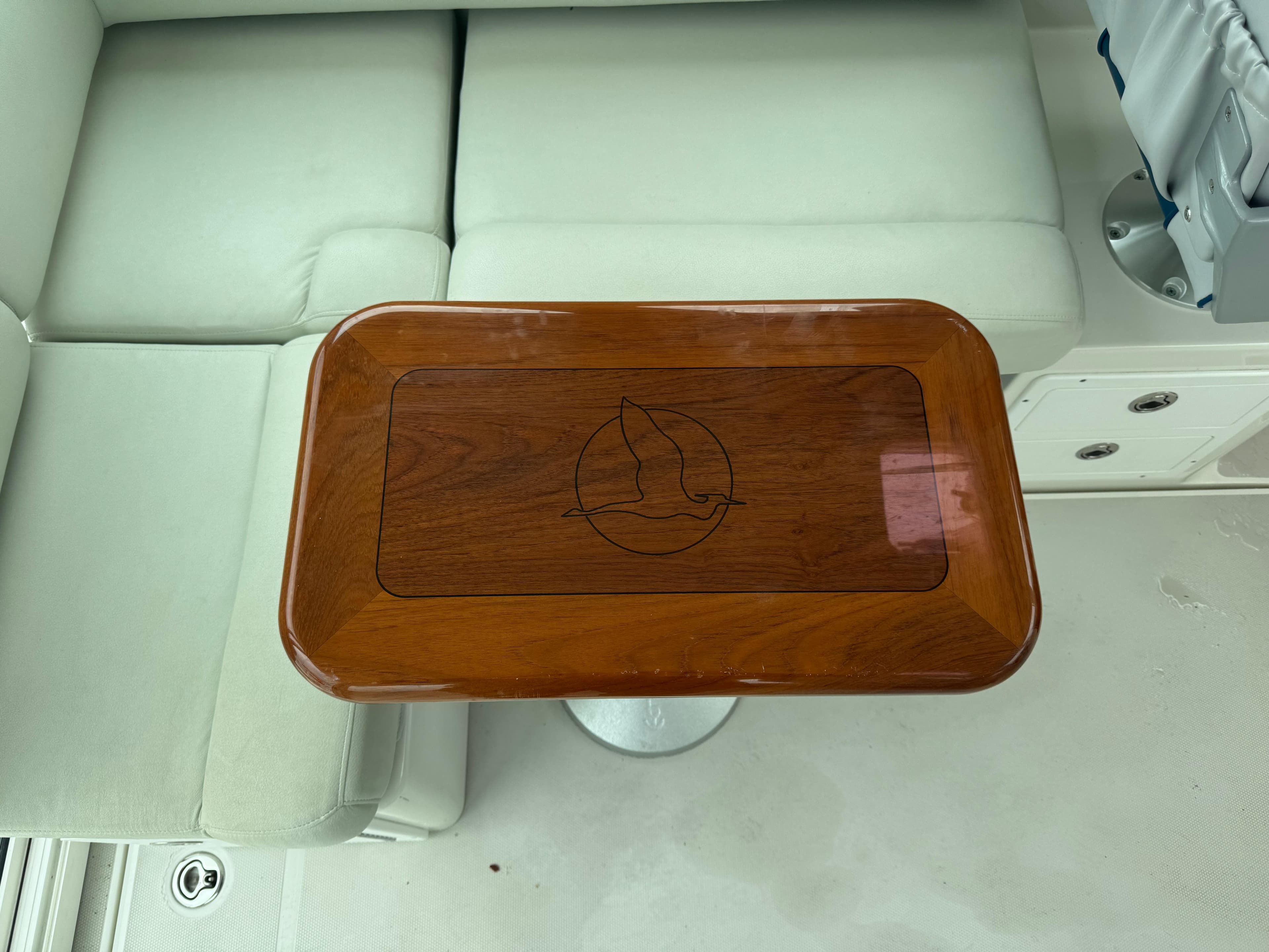 2008 Back Cove 29 Hardback boat interior with wooden table and cushioned seating.
