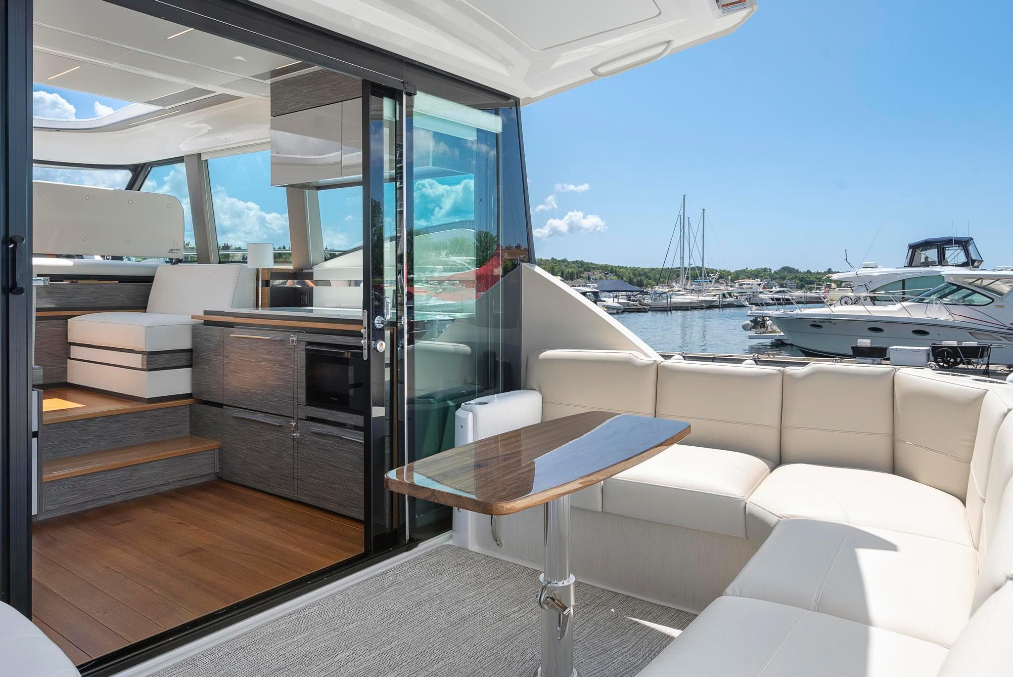 2022 Tiara Yachts C49 Coupe interior with luxurious seating and marina view.