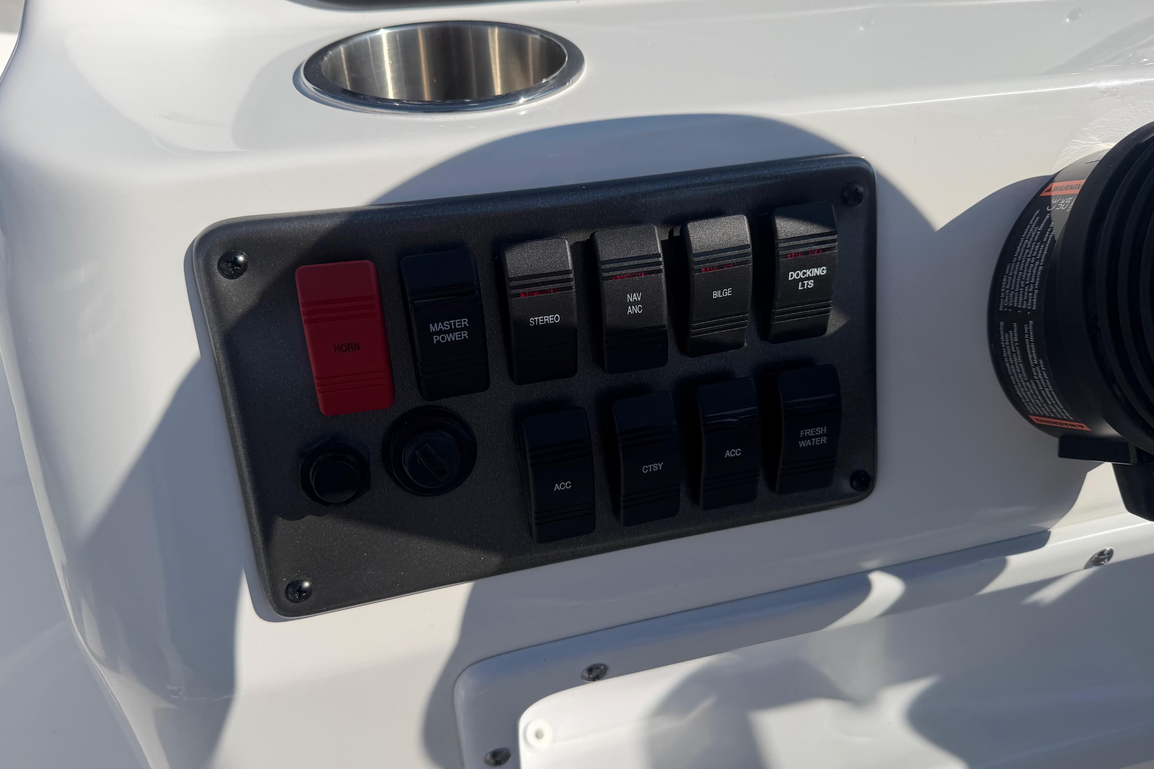 Control panel of 2026 Hurricane FunDeck 198 RE OB boat with various switches.