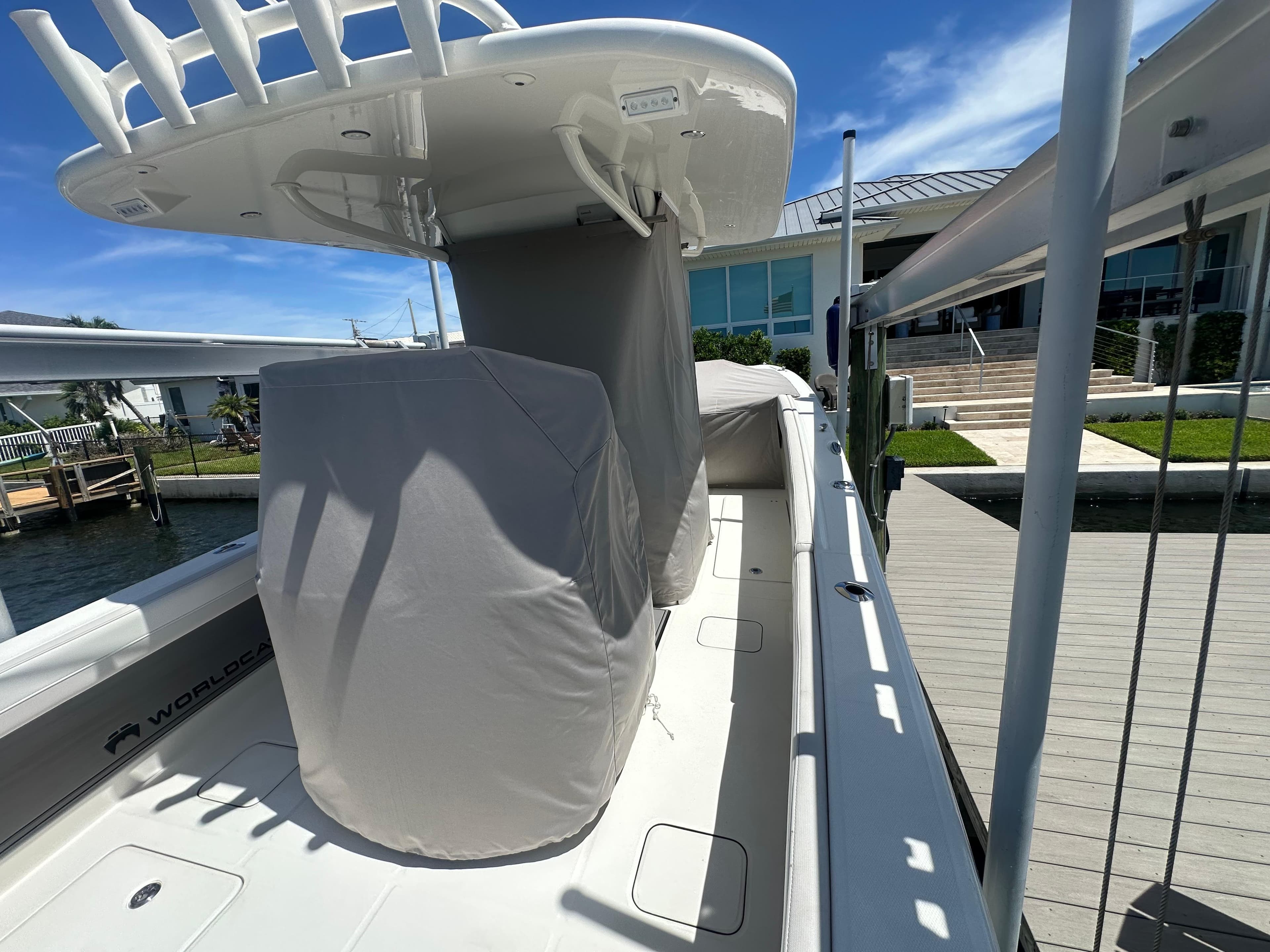 2024 World Cat 280ccx boat docked, featuring covered seating and a sleek design.