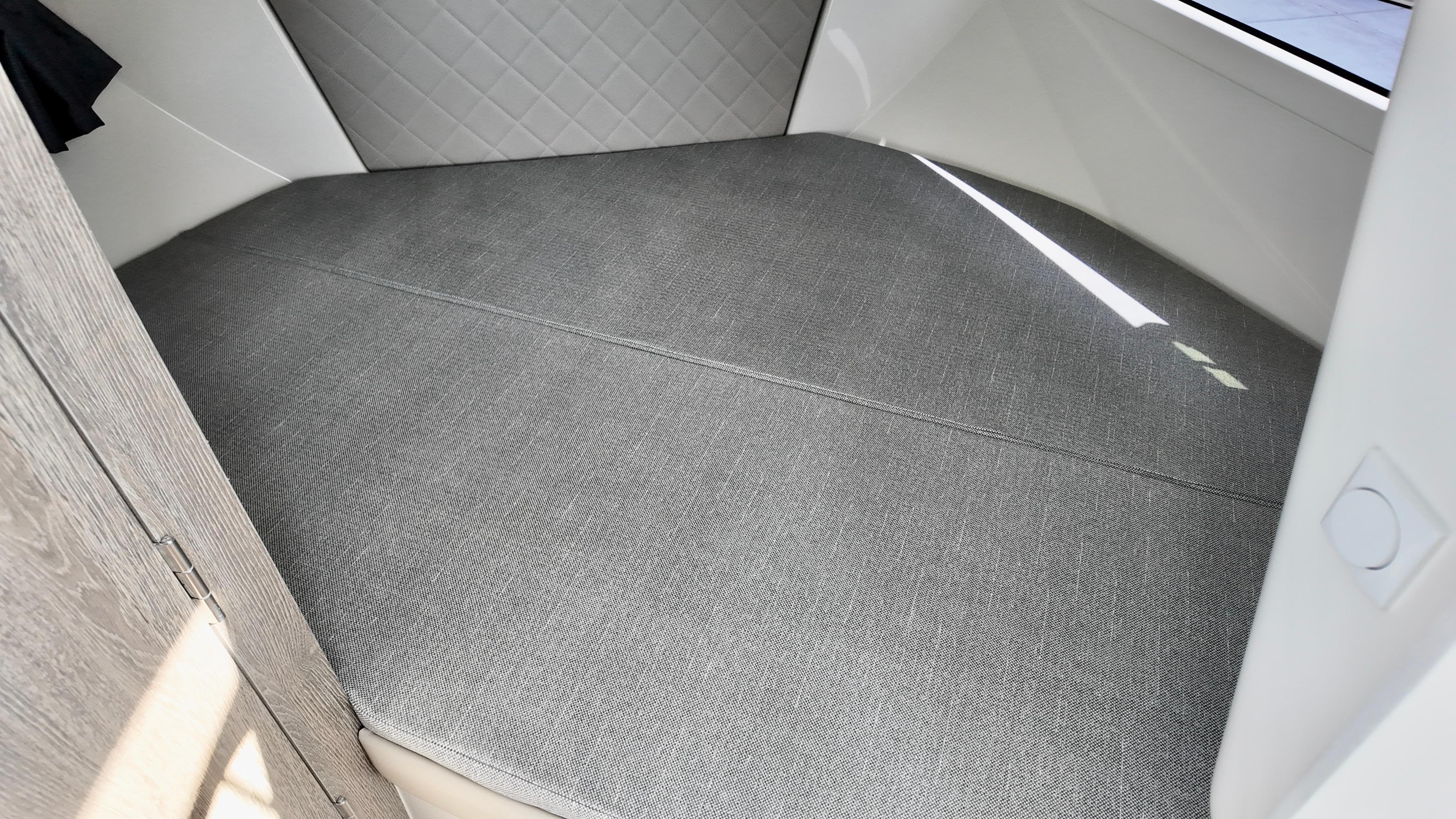 2025 Bayliner TROPHY 25 EXPLORER cabin interior with gray cushioned seating.