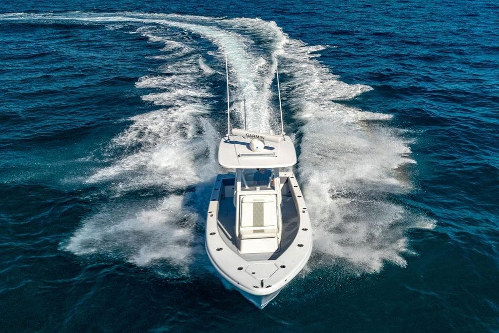 2024 Reef Runner 230 Open boat cruising on open ocean waters.