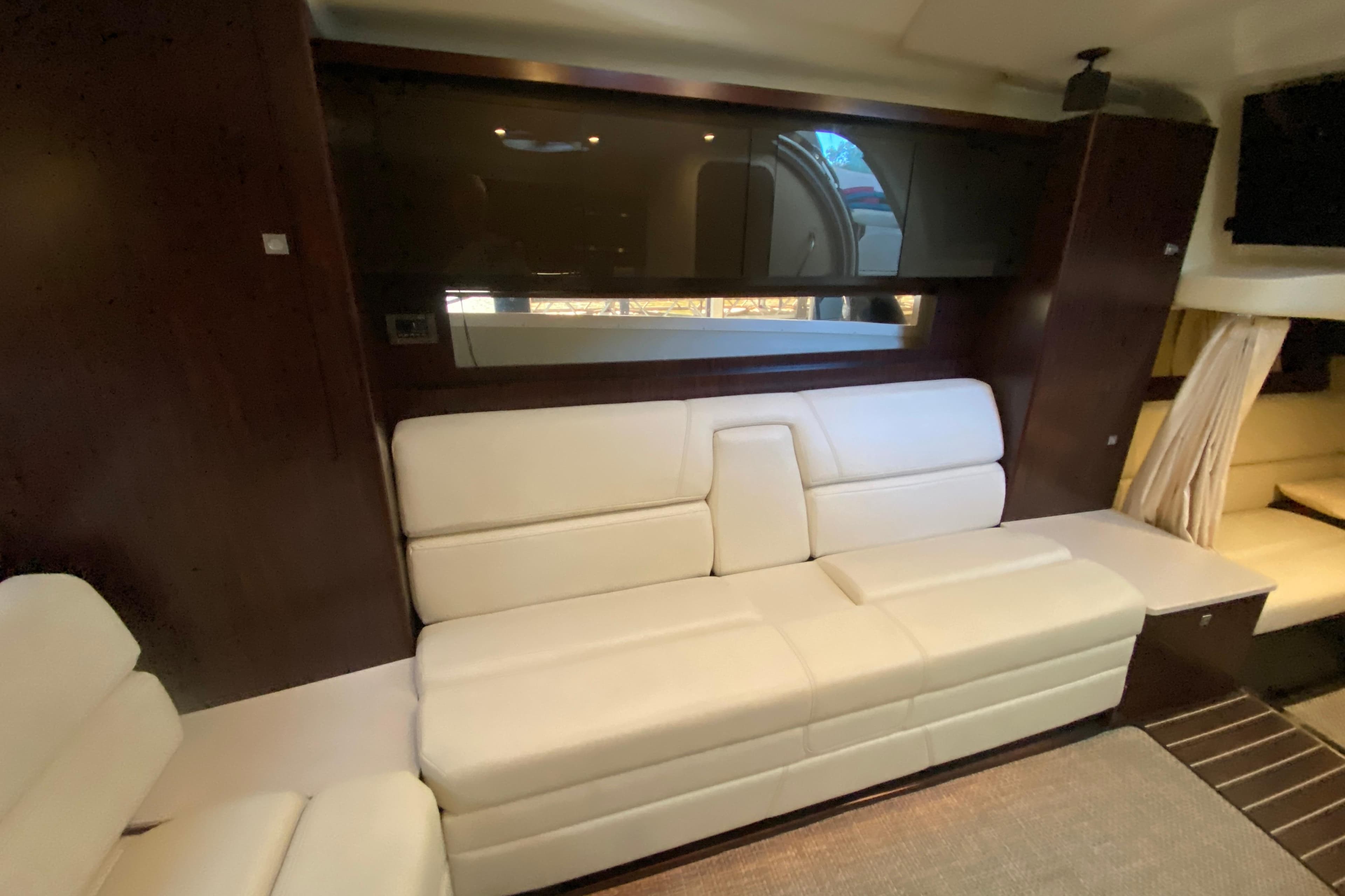 Luxurious interior of 2017 Monterey 355 Sport Yacht with white leather seating.