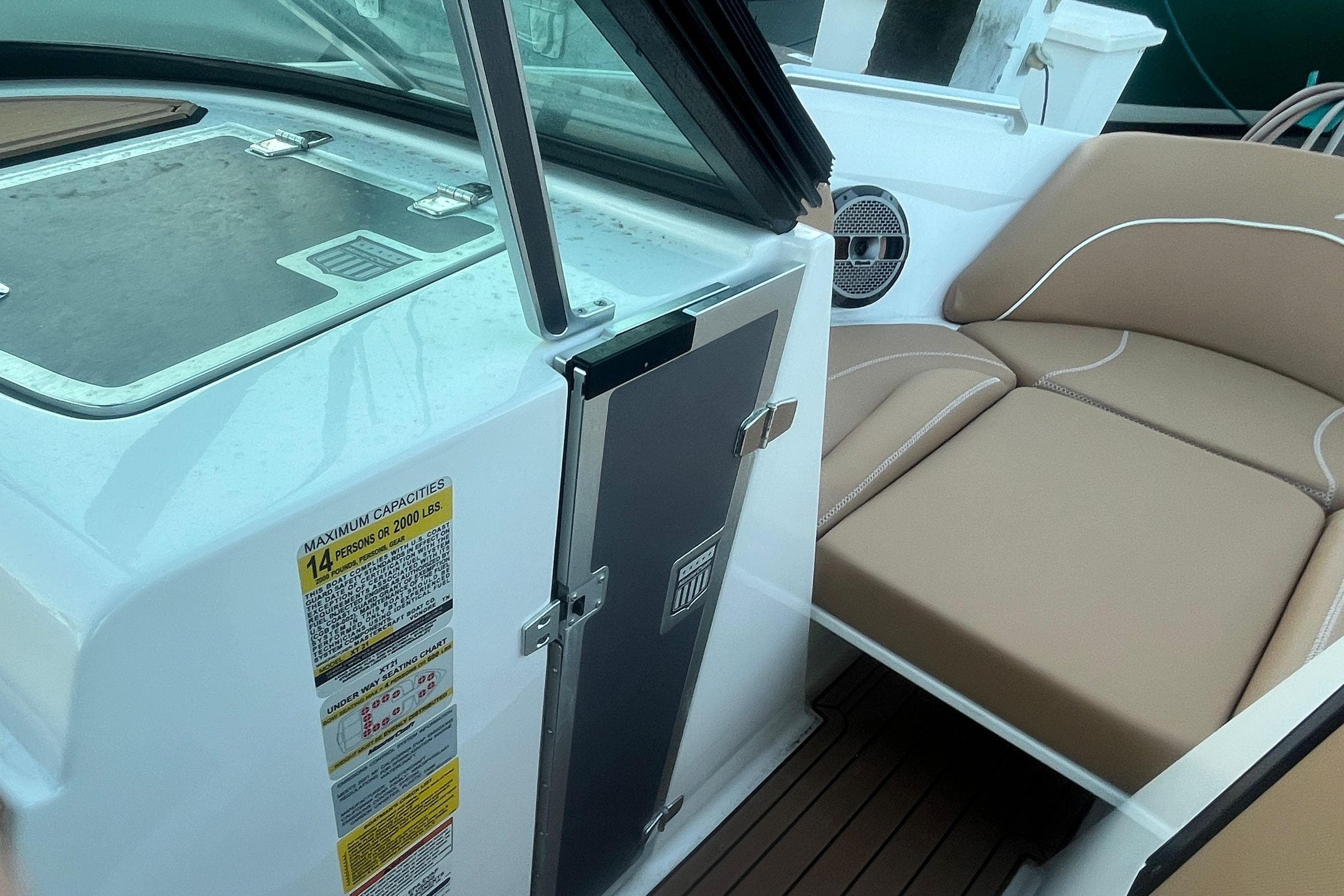 2021 MasterCraft XT21 boat interior with seating and capacity label.
