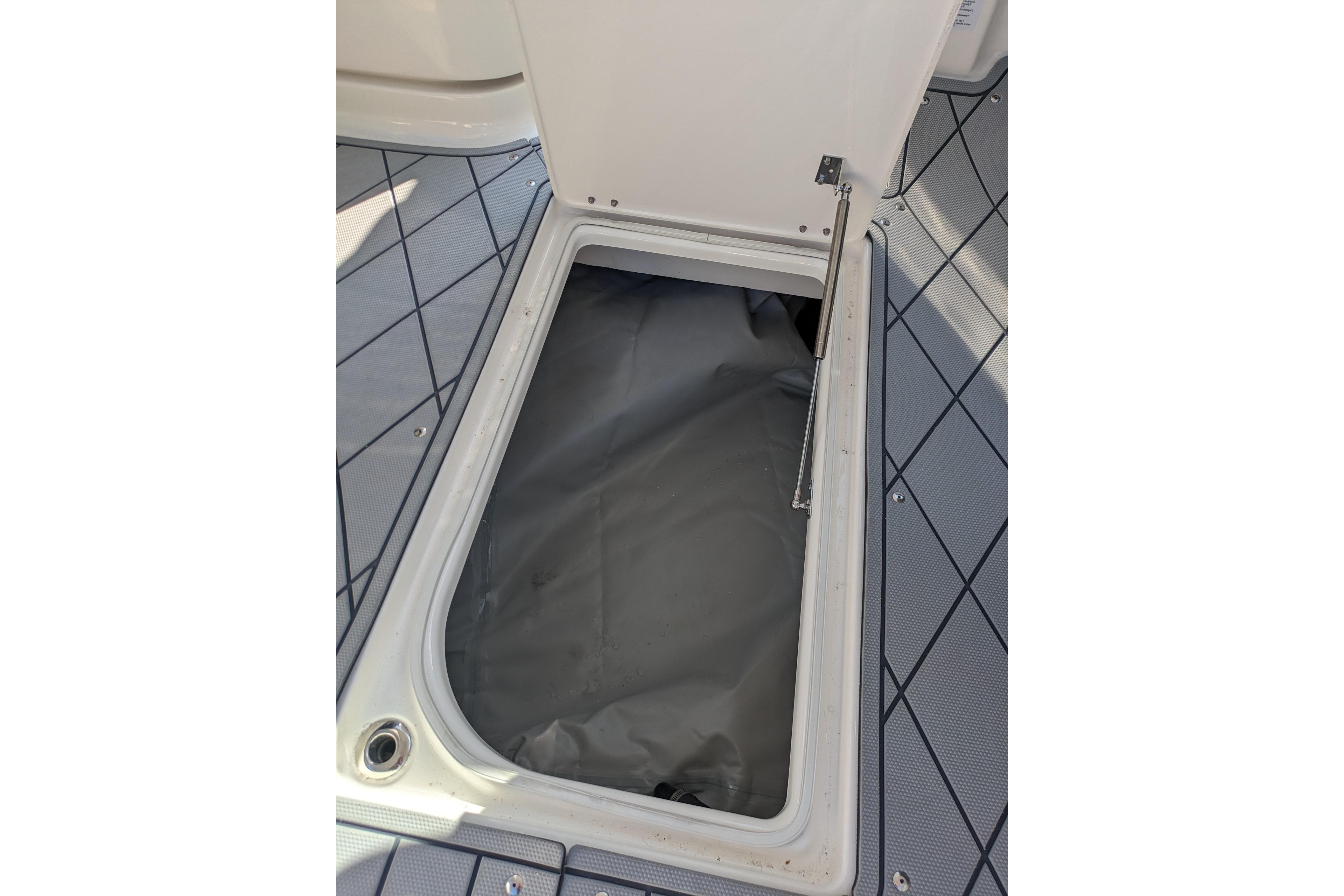 Open storage compartment on 2026 Chaparral 6 GTS boat deck.