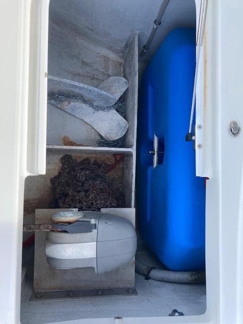 Storage compartment in a 2018 Lagoon 380 catamaran with anchor and blue water tank.